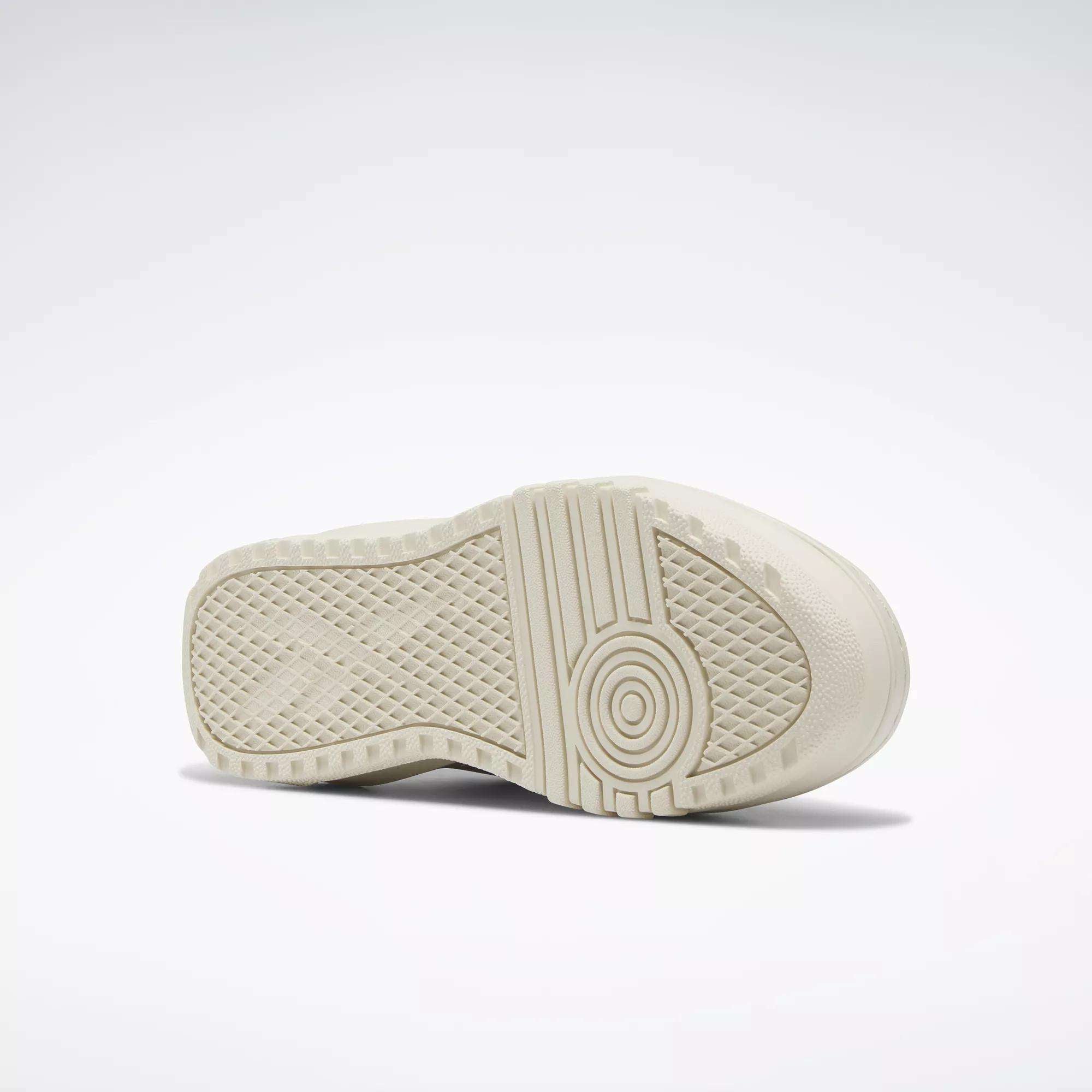 A close-up of the off-white rubber sole on Reebok Women's Club C Extra Shoes, showing its geometric tread pattern and platform midsole, set against a plain white background.