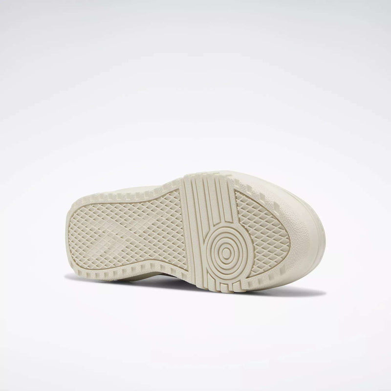 A close-up of the off-white rubber sole on Reebok Women's Club C Extra Shoes, showing its geometric tread pattern and platform midsole, set against a plain white background.