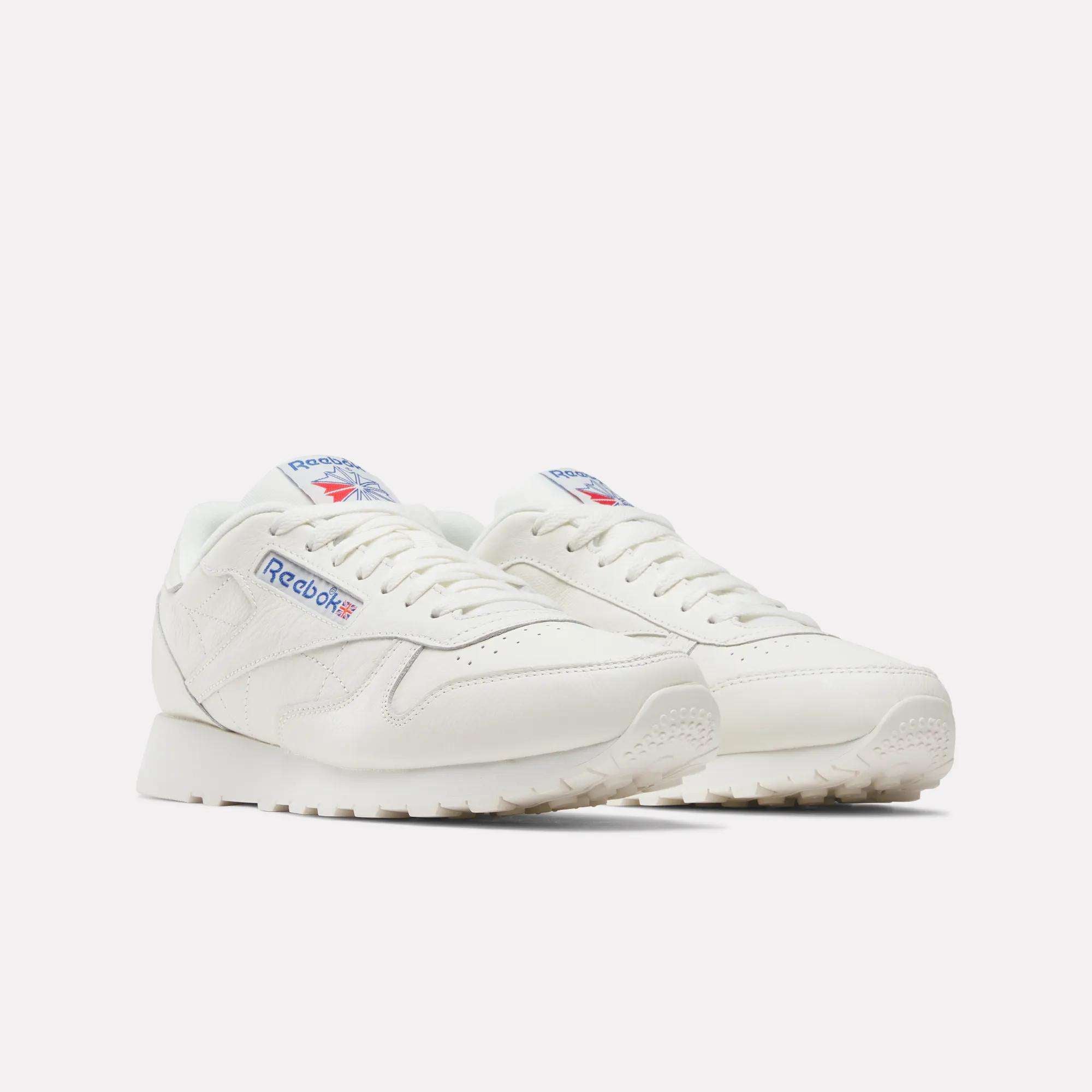 Reebok Classic Leather Shoes in white, made from durable leather with retro blue and red logo accents, displayed on a plain white background.