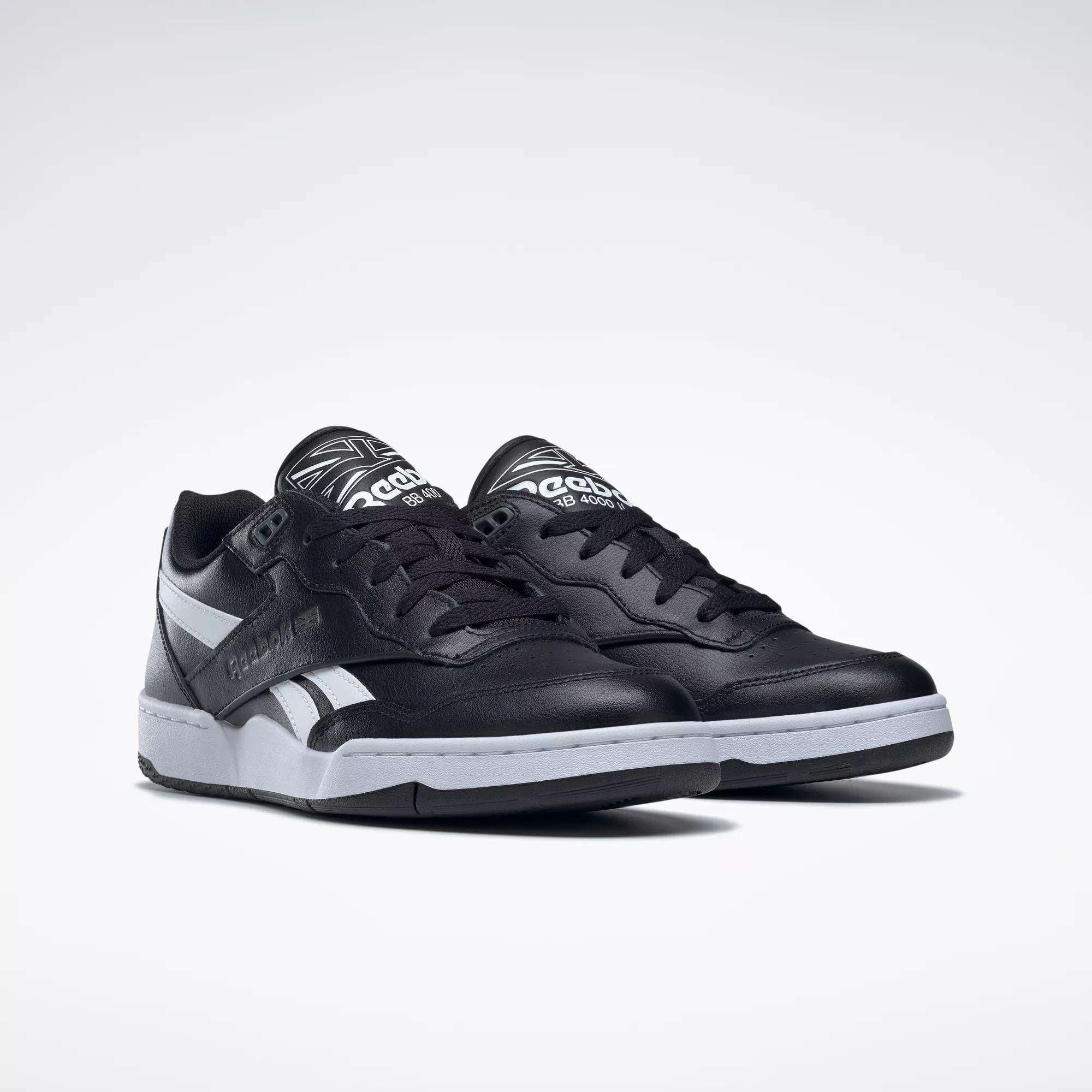 A pair of Reebok BB 4000 II Shoes in black with white soles and silver accents, featuring the Reebok logo on the side and tongue, shown against a plain white background.