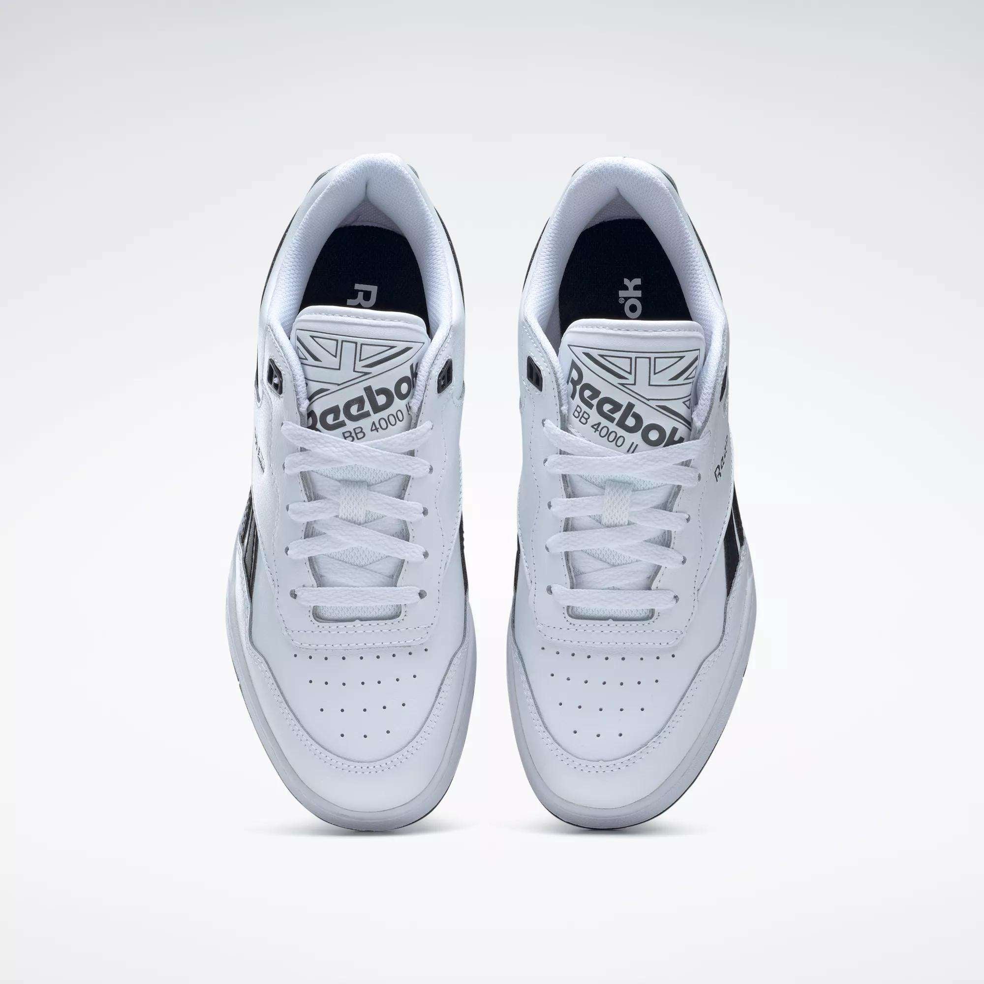 A pair of BB 4000 II Shoes by Reebok shown from above, with white uppers, black accents, perforated toe boxes, white laces, and branded tongues for a classic vintage basketball look.