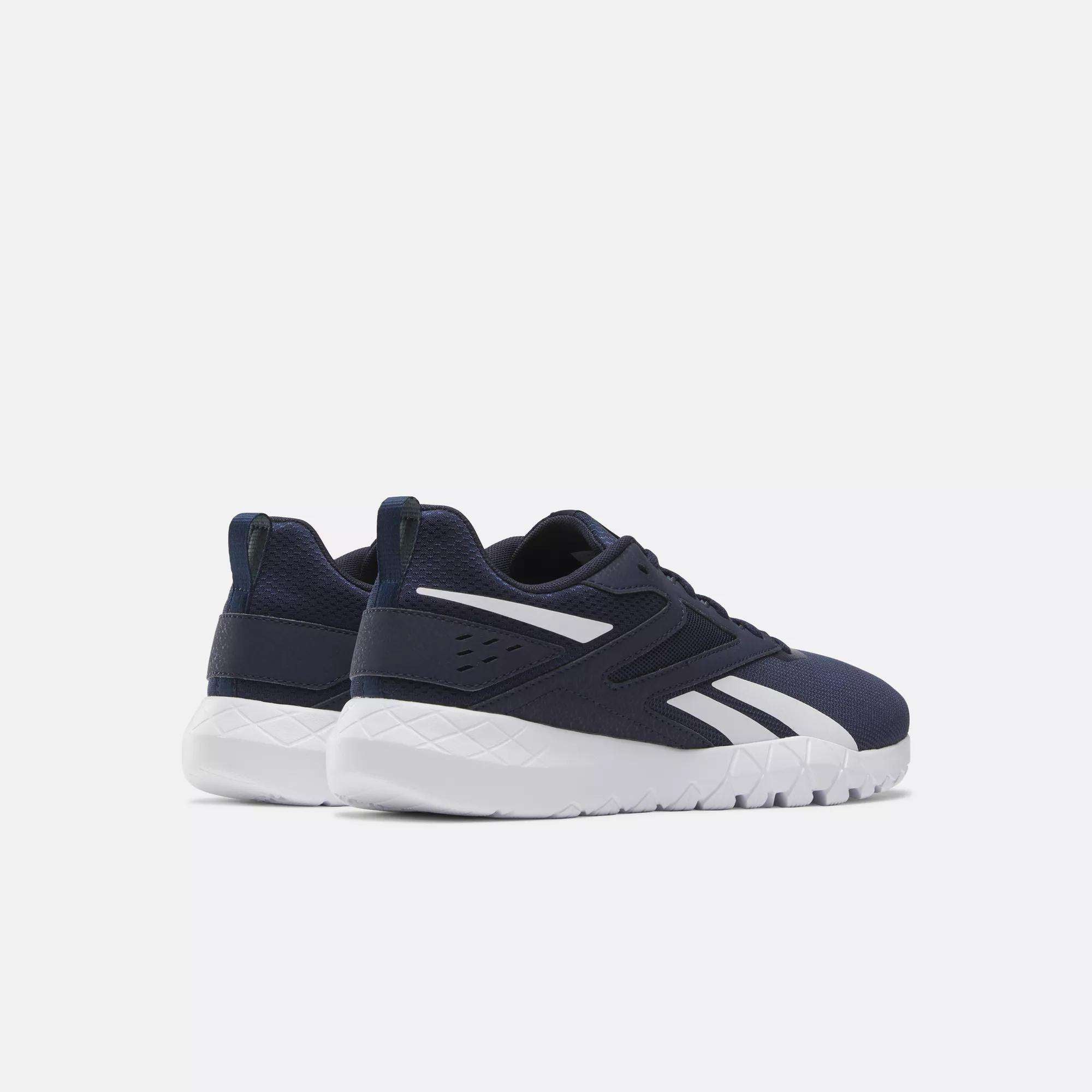 A pair of Reebok Men's Flexagon Energy 4 Training Shoes in navy blue with white soles and accents, made from breathable mesh, displayed on a plain light background showing the side and back views.