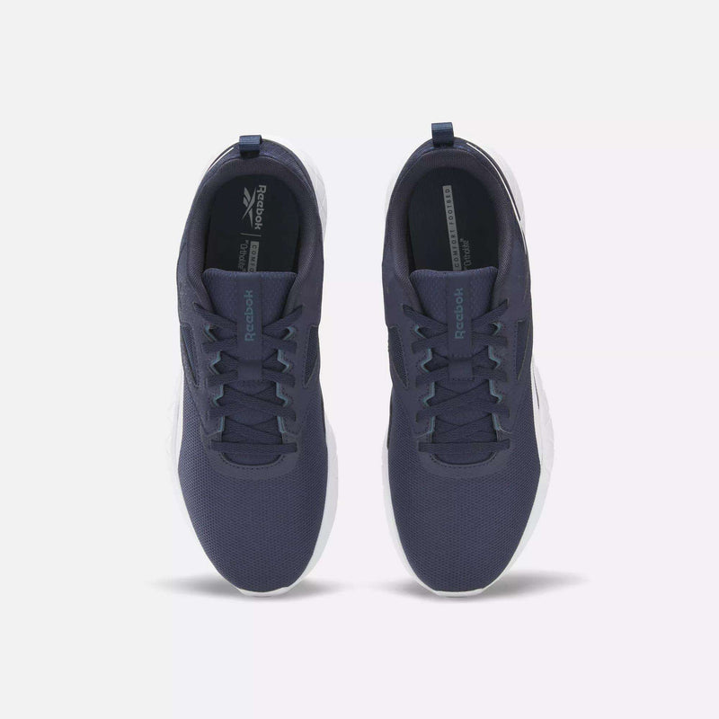 A pair of Reebok Men's Flexagon Energy 4 Training Shoes in navy blue with white soles, shown from above on a light background. They feature breathable mesh uppers, laces, and visible Reebok branding on the tongue and insole.