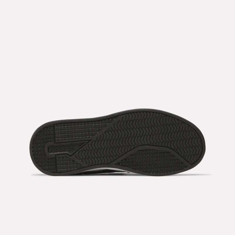 The image shows the sole of a black Kids' Reebok Royal Prime 2 Shoe featuring textured grip patterns and the Reebok logo on the left side, set against a plain white background.