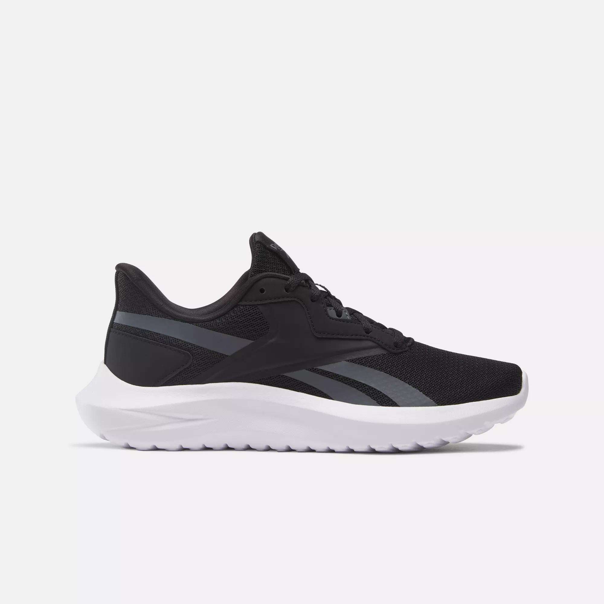 The Reebok Women's Energen Lux Running Shoes feature a black mesh upper with dark gray accents and a white sole. Displayed in side profile against a plain light background, these versatile sneakers are ideal for running.