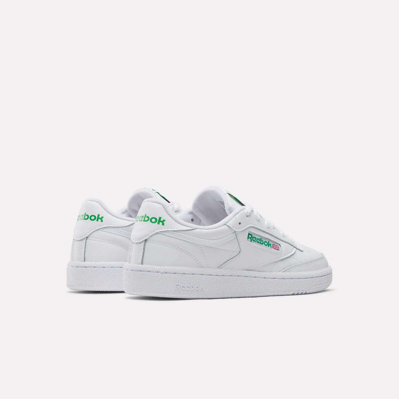 Reebok Women's Club C 85 Shoes feature classic white design with green logos on the side and heel, shown against a plain light background—timeless sneakers perfect for any casual outfit.