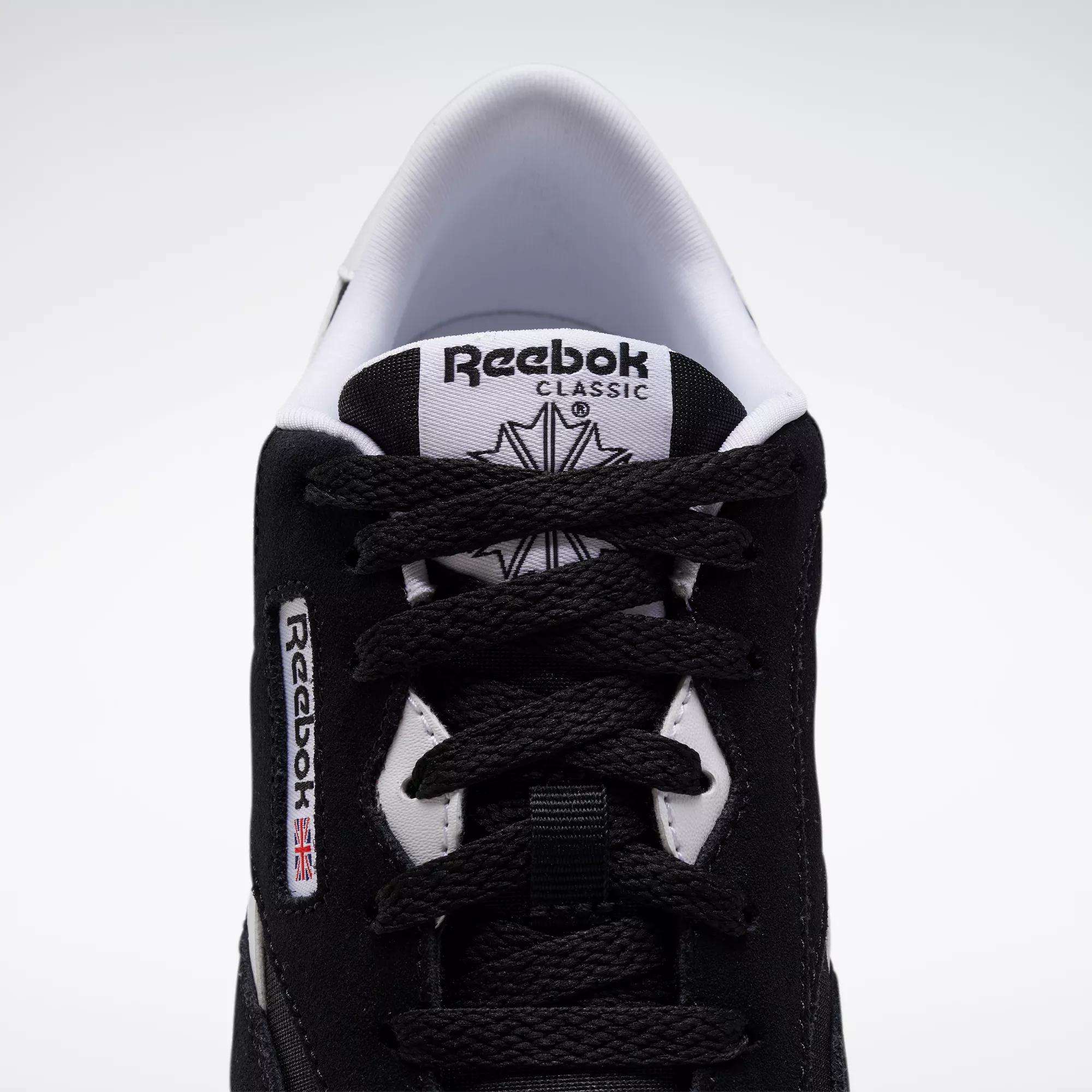 Top view of Reebok Classic Nylon Shoes - Big Kids, in black with white accents, minimalist 80s-inspired design, visible laces, branded tongue, and side label featuring a small Union Jack flag.