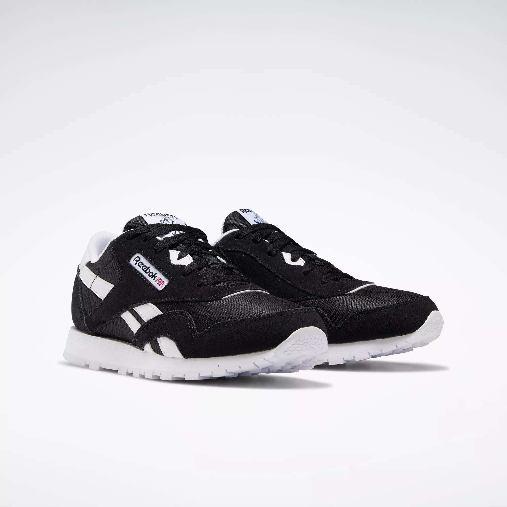 Reebok Classic Nylon Shoes - Big Kids in black with white accents and soles, showcasing a minimalist design inspired by iconic 80s running shoes.