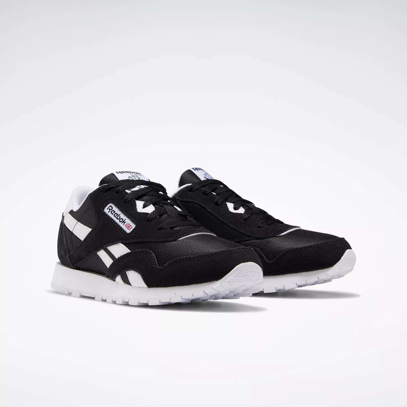 Reebok Classic Nylon Shoes - Big Kids in black with white accents and soles, showcasing a minimalist design inspired by iconic 80s running shoes.
