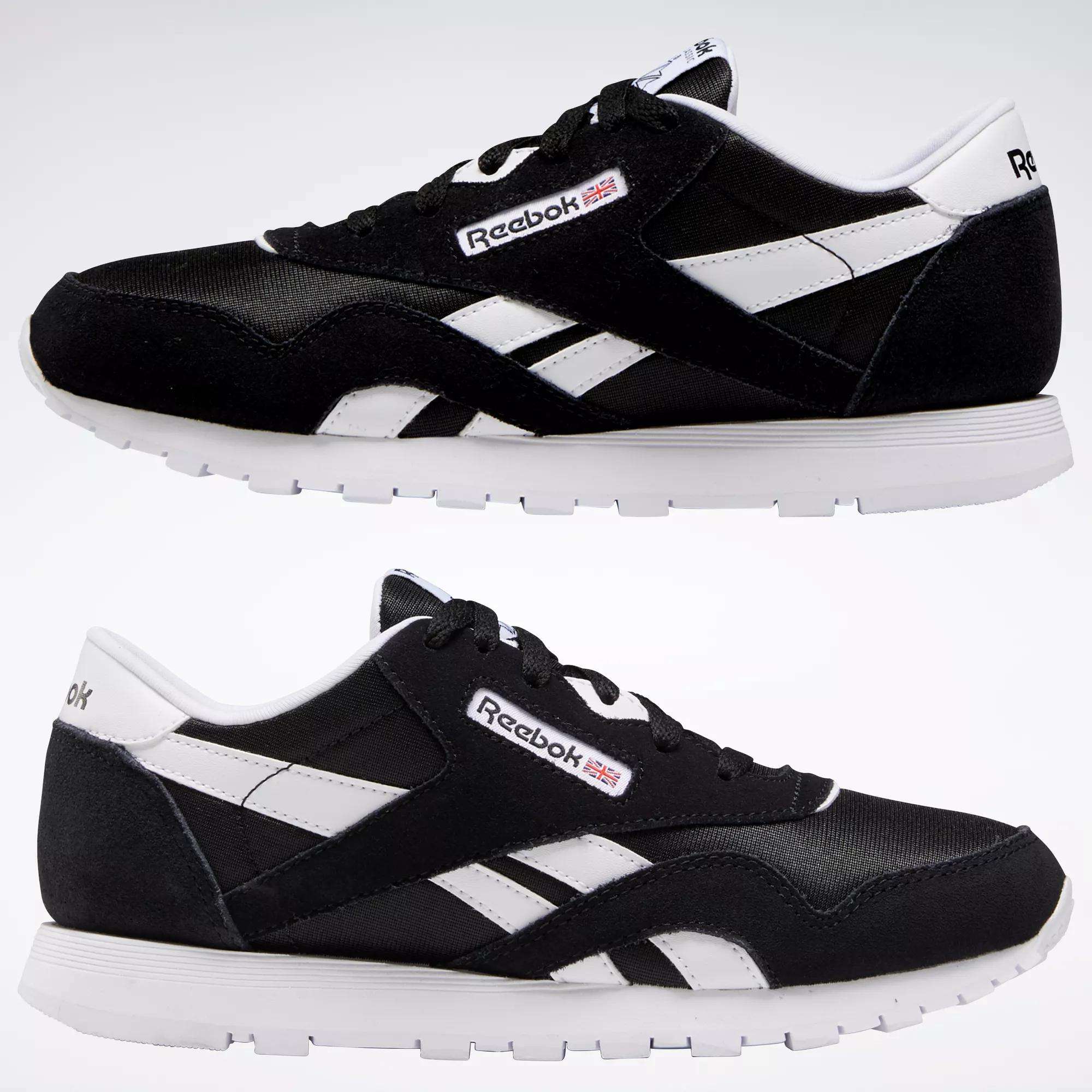 Two pairs of Reebok Classic Nylon Shoes for big kids, featuring black and white colors, white soles, and visible Reebok branding, are displayed side by side against a plain white background.