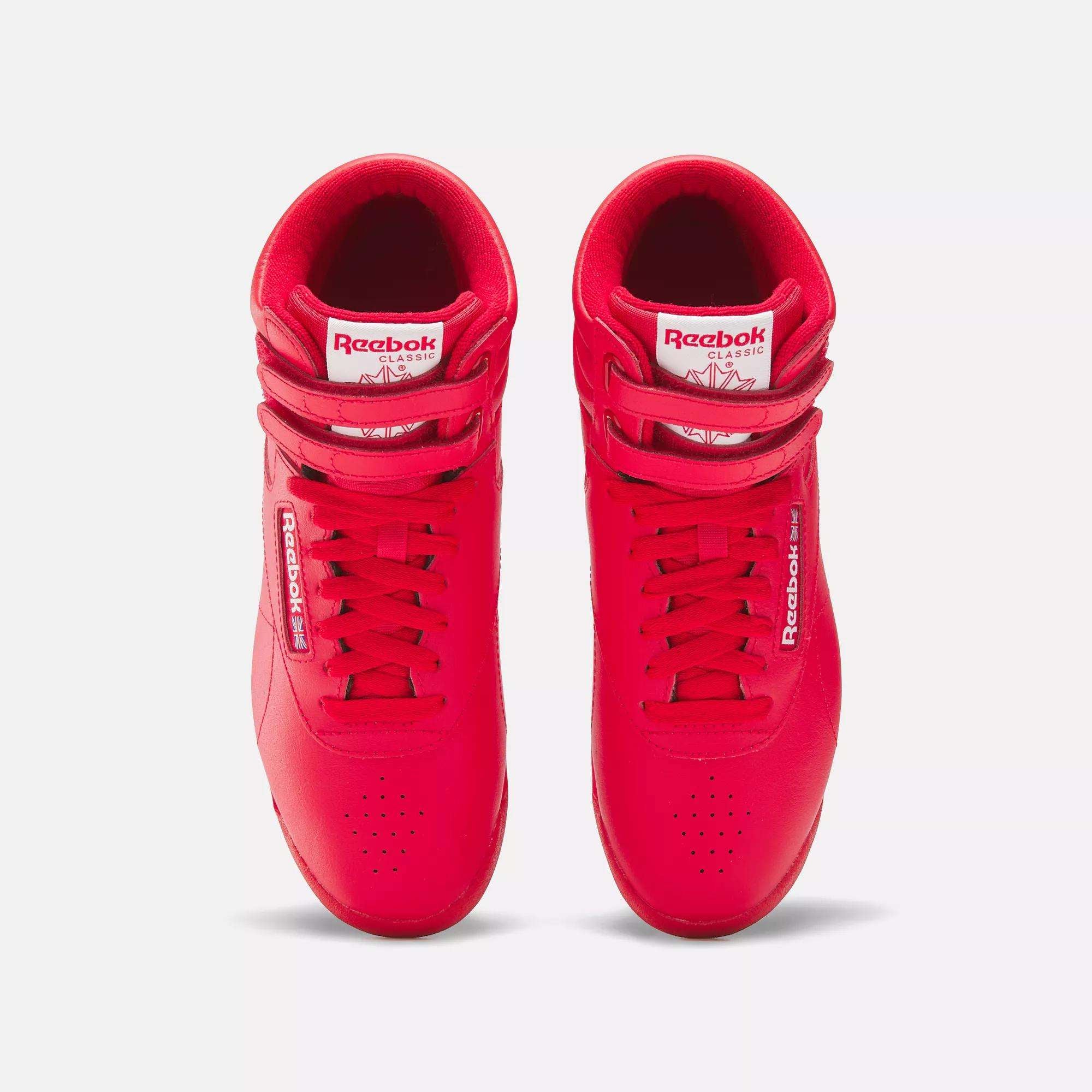 Reebok Women's Freestyle Hi Shoes in bright red, designed for fitness with laces and double velcro straps, shown from above on a white background.