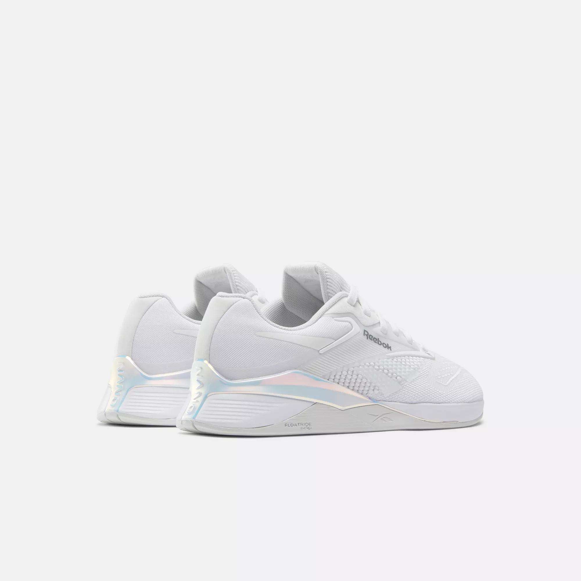 A pair of Reebok Nano X4 Women's Training Shoes in lightweight white with subtle iridescent heel accents, shown on a plain light gray background.