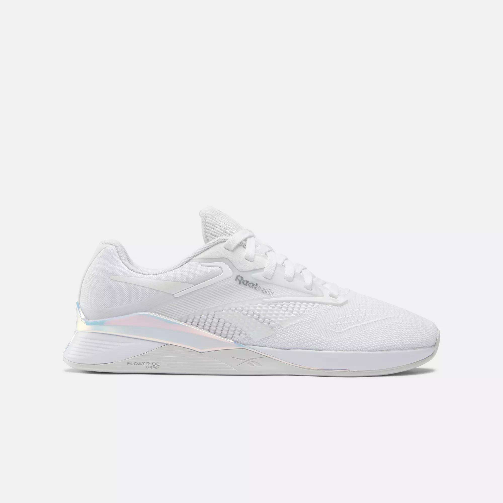 The Reebok Nano X4 Women's Training Shoes feature a white breathable mesh upper, white laces, and a subtle iridescent heel accent, displayed in side profile against a plain white background.