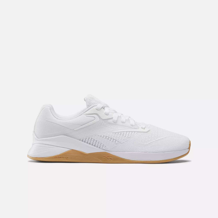 The Reebok Women's Nano X4 Training Shoes feature a white textured mesh upper, white laces, and a tan rubber sole—lightweight, breathable trainers shown in a side view on a plain white background.