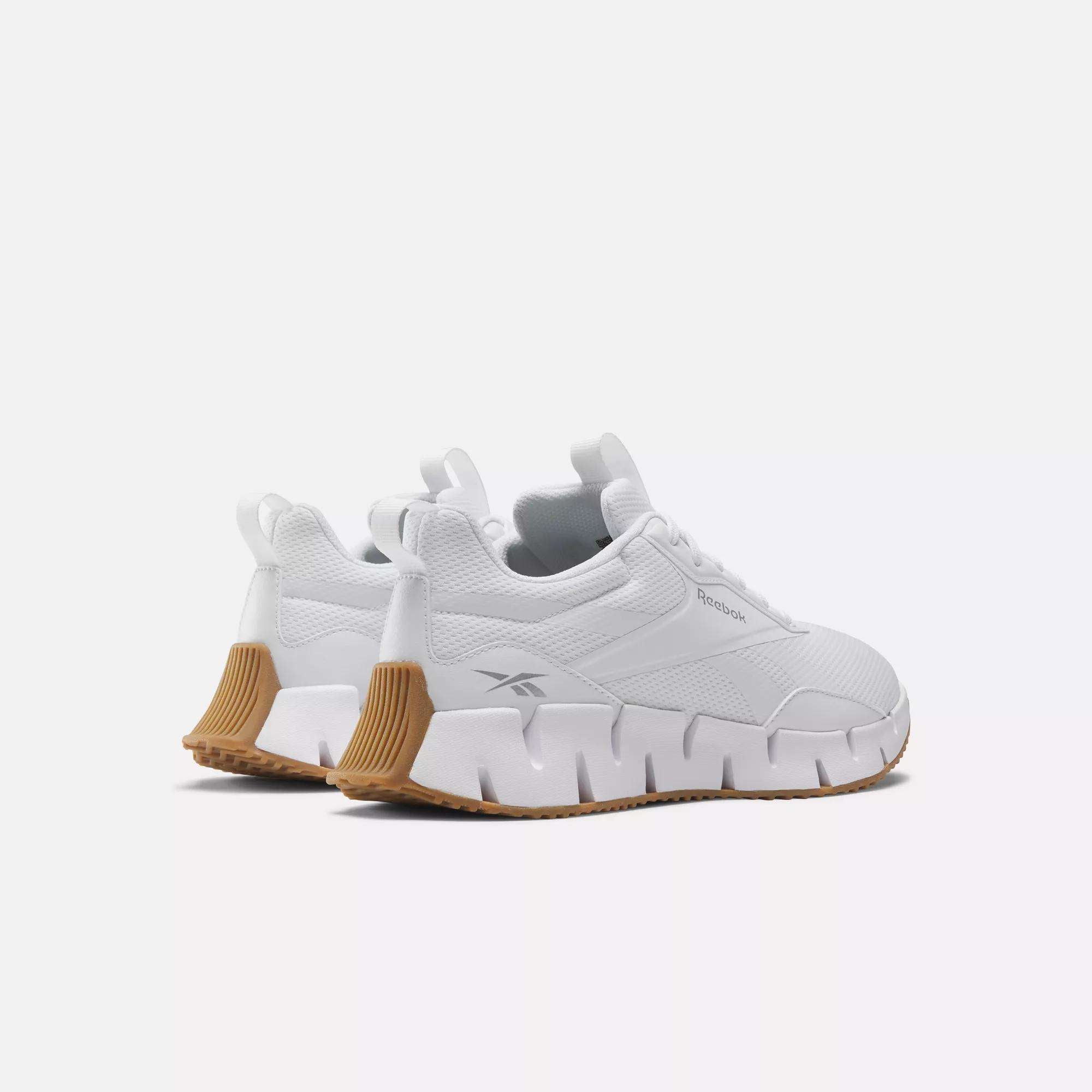 The Reebok Women's Zig Dynamica STR Shoes feature chunky geometric FuelFoam midsoles and tan rubber outsoles, shown from the back and side on a plain white background.