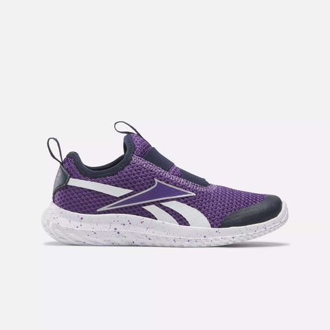 The Reebok Kids' Rush Runner Slip-On Shoes for little kids feature a purple design with a white speckled sole, white accents, and black toe and heel details. Lightweight cushioning is highlighted against a plain light background.