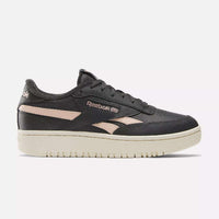 Black Reebok sneaker with beige sole on a white background