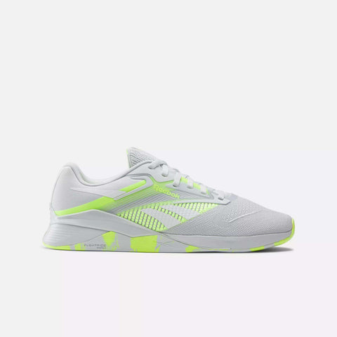 The Reebok Nano X4 Training Shoes feature a white breathable mesh upper, neon yellow-green accents, white laces, cushioned sole, and lightweight design—perfect for running or training. Displayed on a plain light background.