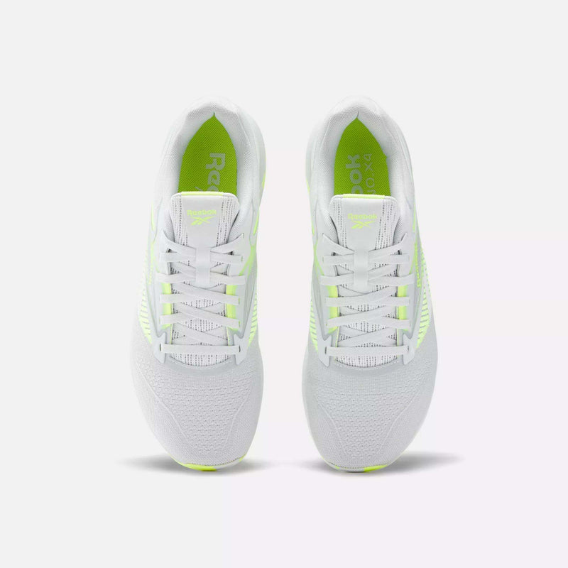 The Reebok Nano X4 Training Shoes are lightweight and white with neon yellow accents, shown from above on a plain white background. They feature breathable mesh uppers and white laces for comfort and style.