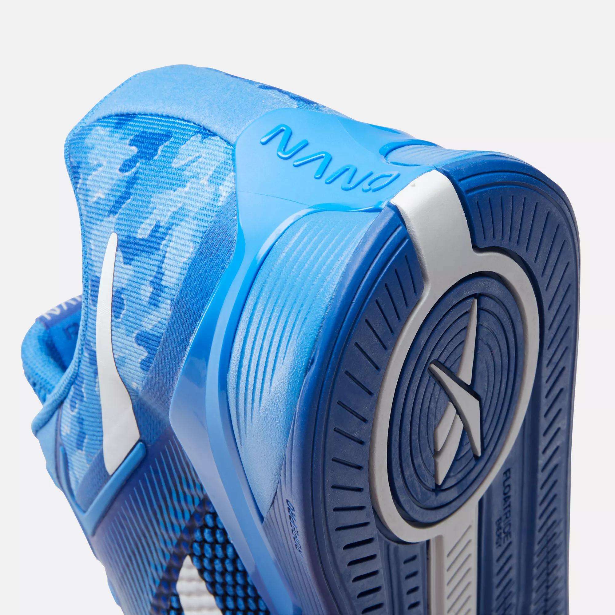 Close-up of Reebok Nano X4 Training Shoes, featuring a lightweight blue design with white accents, textured sole, Nano branding, hexagonal side pattern, and camouflage heel for breathability, style, and performance during training.