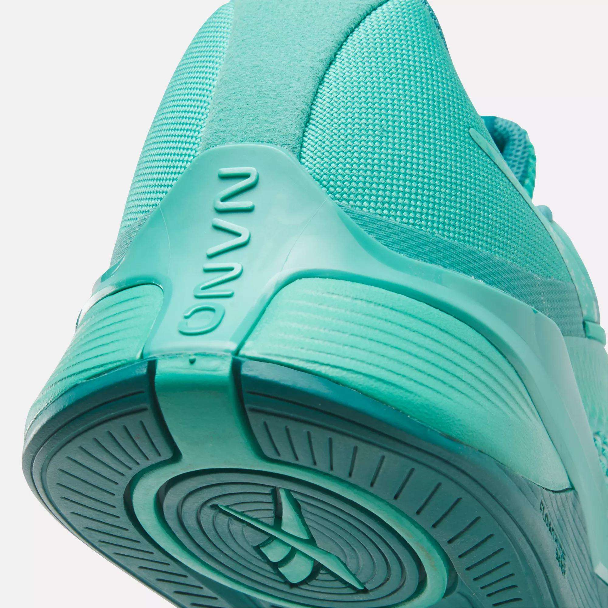Close-up view of the heel and sole of a turquoise Women's Nano X4 Training Shoe, showing textured details, curved lines, and the brand name Reebok embossed on the heel.