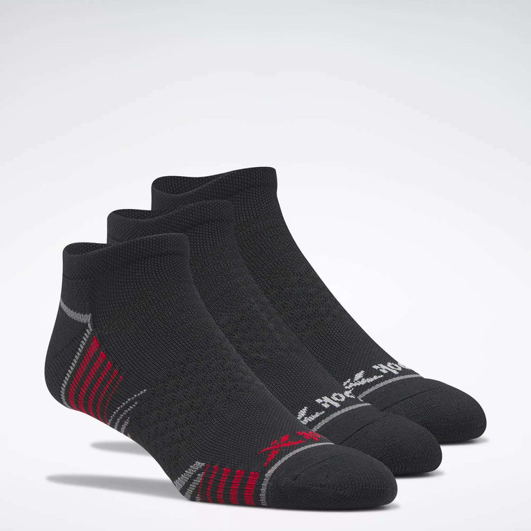 Three pairs of Reebok Men's Performance Nylon Low Cut Socks are displayed on a white background, featuring athletic style and moisture-wicking comfort for active performance.