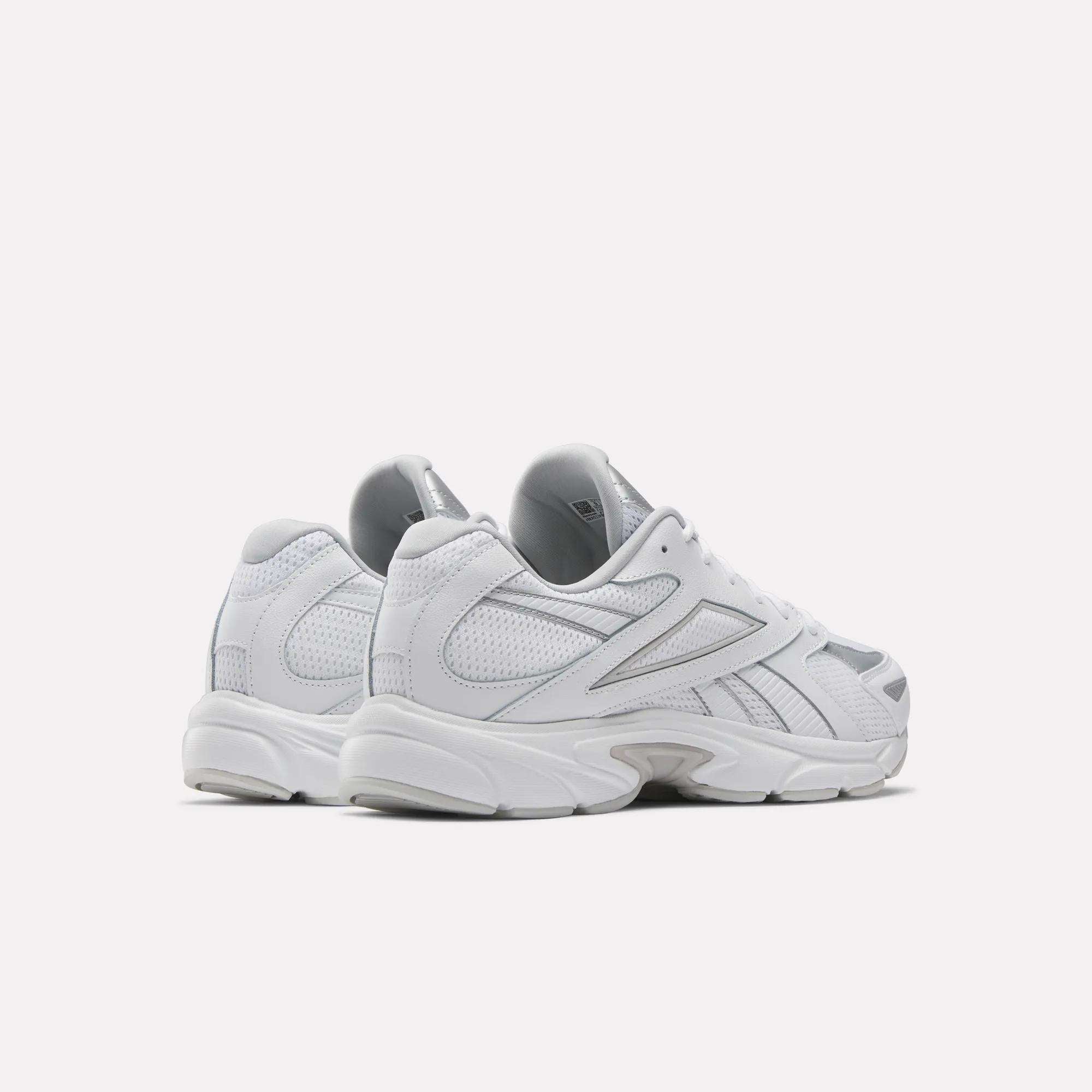 The Reebok Road Prime Shoes, shown from the back and side in white with silver accents, showcase classic Y2K running style against a plain white background.