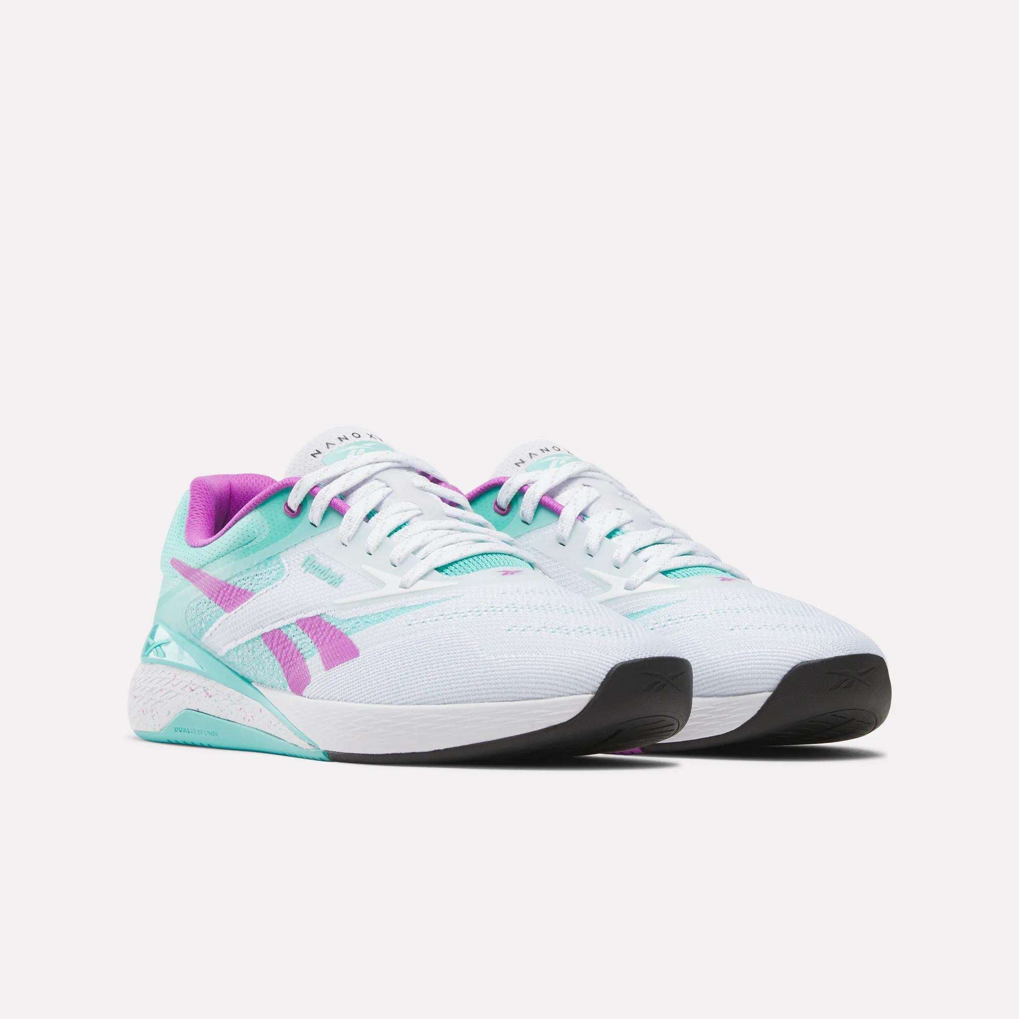 The Reebok Nano X5 Training Shoes are men's white trainers with turquoise soles, pink accents, a purple inner lining, and the Reebok logo on the side, shown on a plain white background.