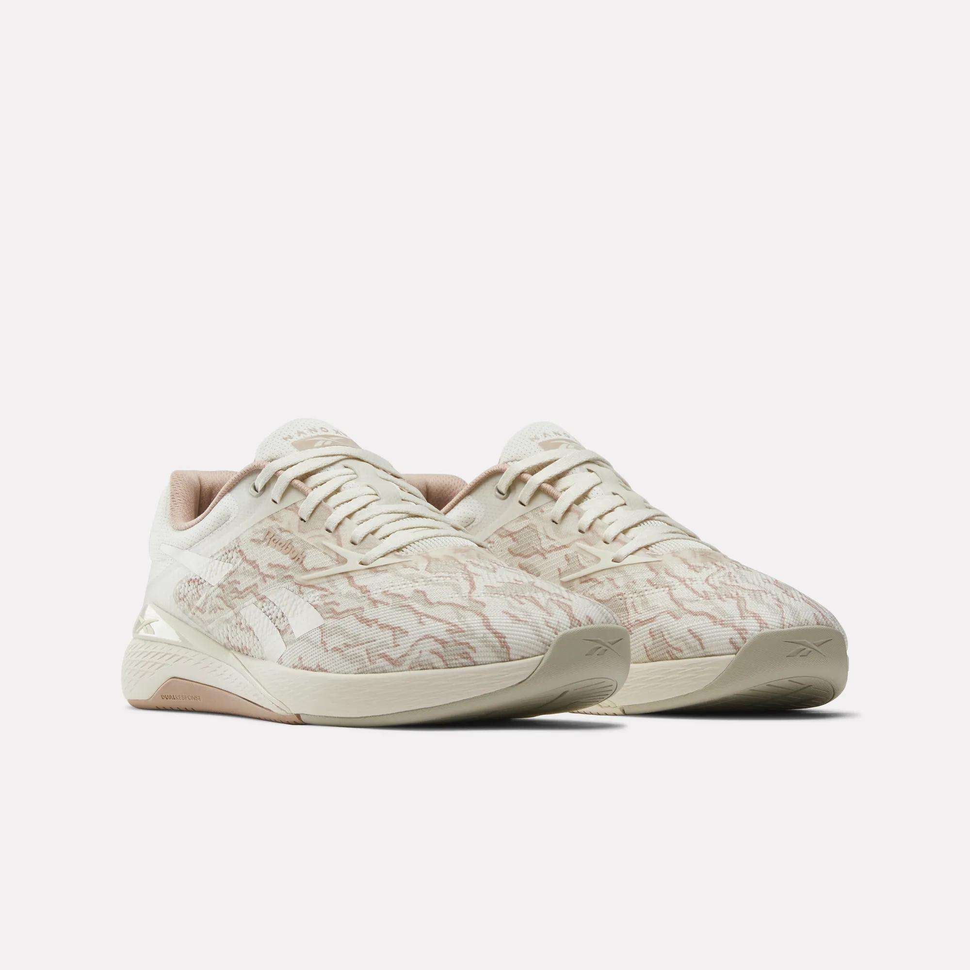 The Reebok Nano X5 men's training shoes feature a beige, patterned textured upper with light brown accents, displayed against a plain white background.