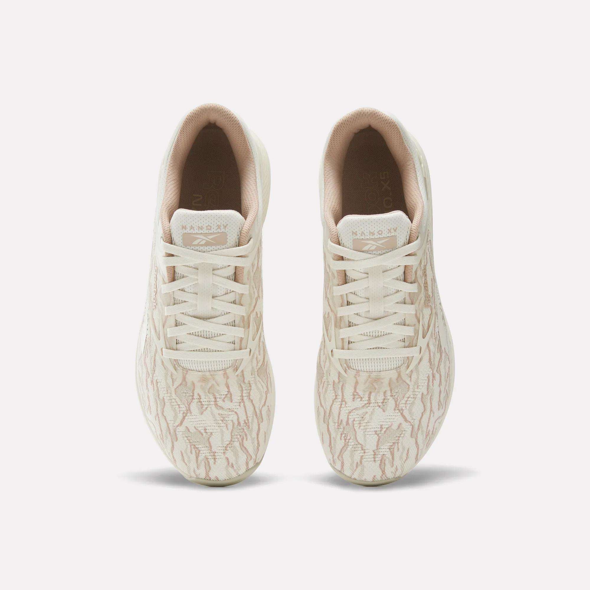 A pair of beige Reebok Nano X5 Training Shoes for men, seen from above, with subtle wavy patterns, light-colored laces, and a comfortable inner lining.