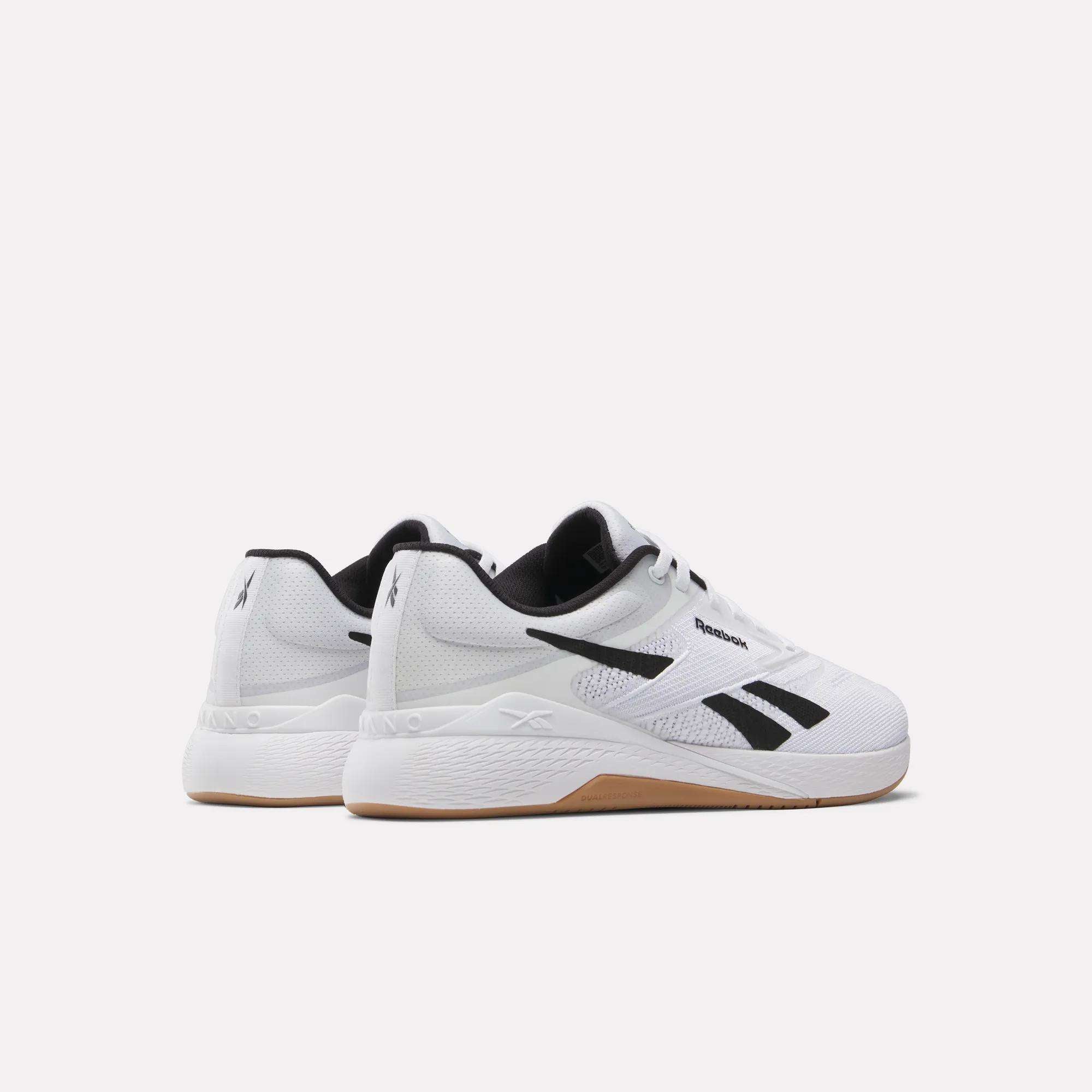 The Reebok Nano X5 Training Shoes feature a white design with black accents and gum soles, positioned side by side on a plain white background—delivering style and comfort for your workouts.