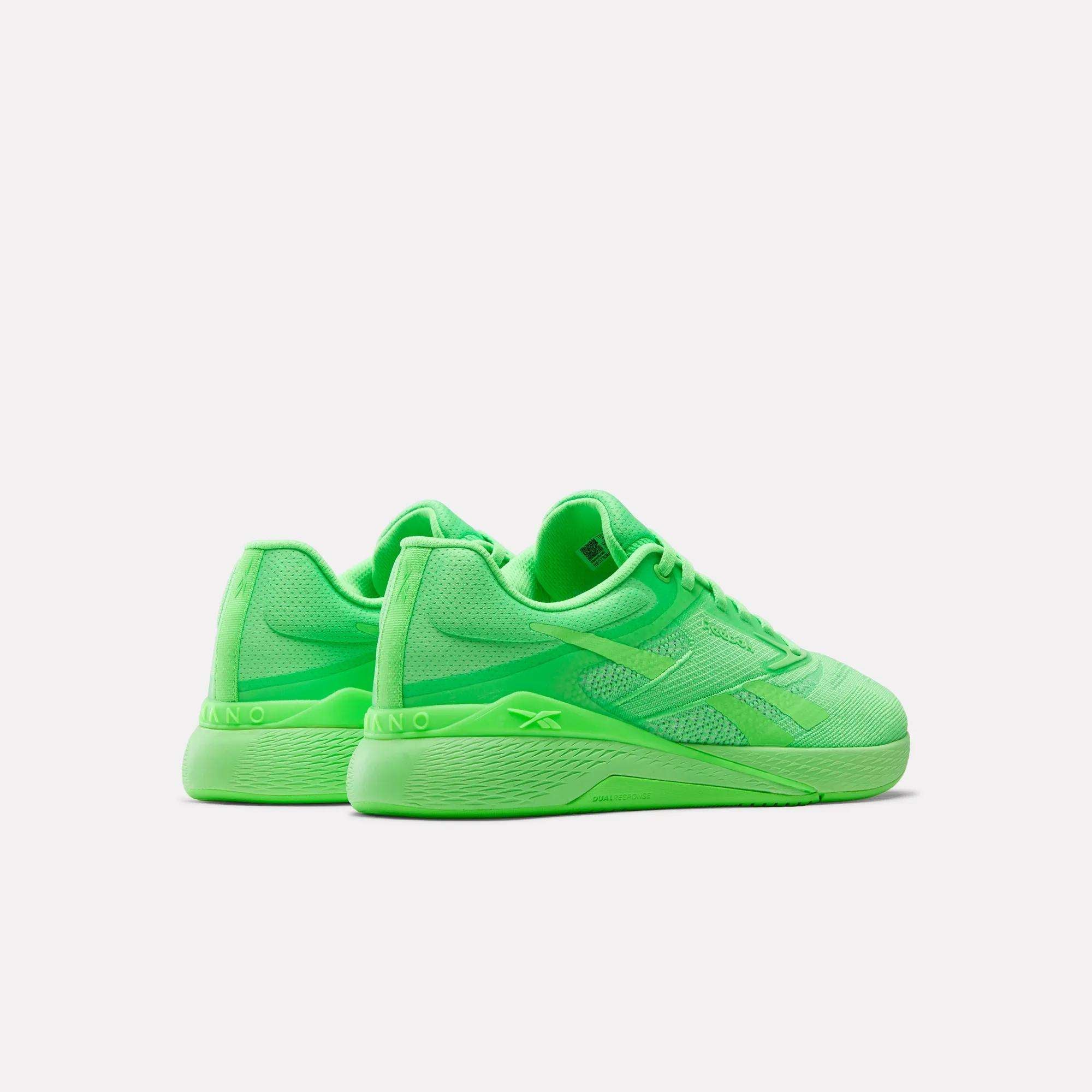 The Reebok Nano X5 Training Shoes feature bright neon green mesh uppers, secure laces, and textured soles for comfort, shown on a plain white background.