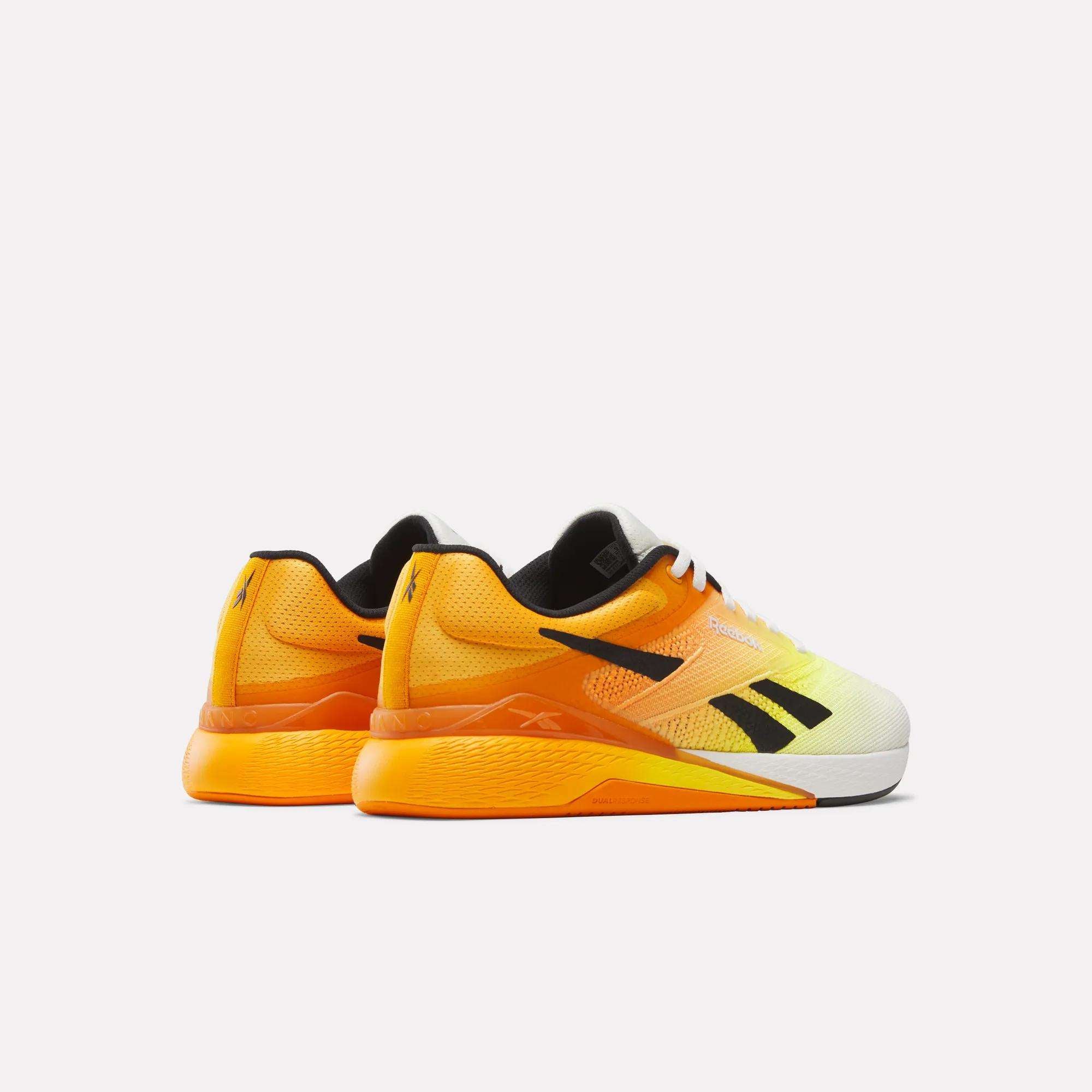 The Reebok Nano X5 Training Shoes for men feature a bright yellow and orange gradient design with black accents and white laces, showcased against a plain white background.