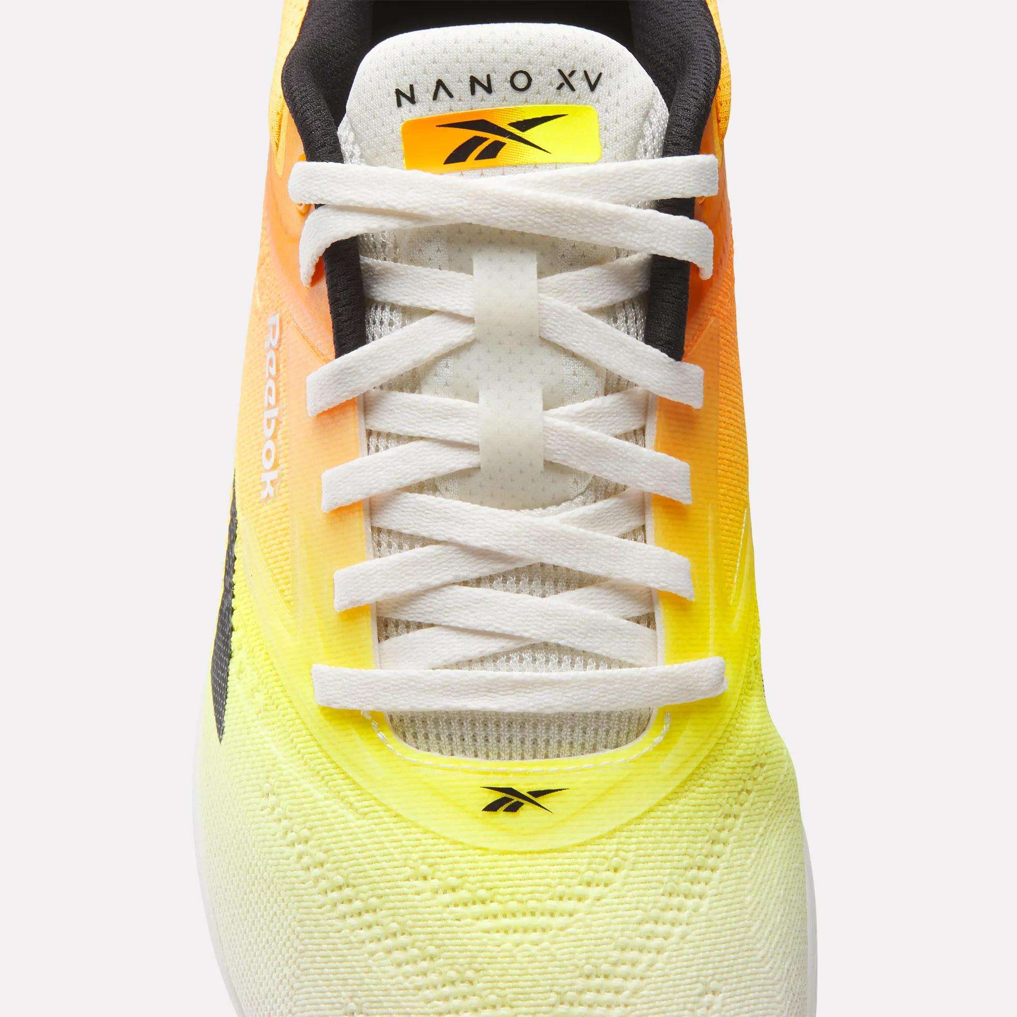 Top view of Reebok Nano X5 Training Shoes, featuring white laces, a gradient yellow-to-orange upper, and visible Reebok logos on the tongue and toe area.