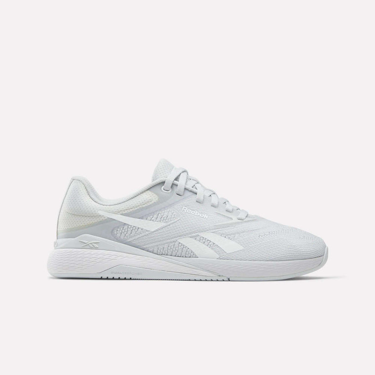 The Women's Nano X5 Training Shoes by Reebok feature a white mesh upper, lace-up closure, and side logo—shown in profile on a white background—offering stylish comfort for women's training.