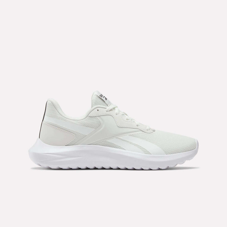 Side view of Reebok Men's Energen Lux Running Shoes in white, featuring a mesh upper, textured sole, and subtle logo details on the side and tongue—ideal for running or casual wear against a plain light background.