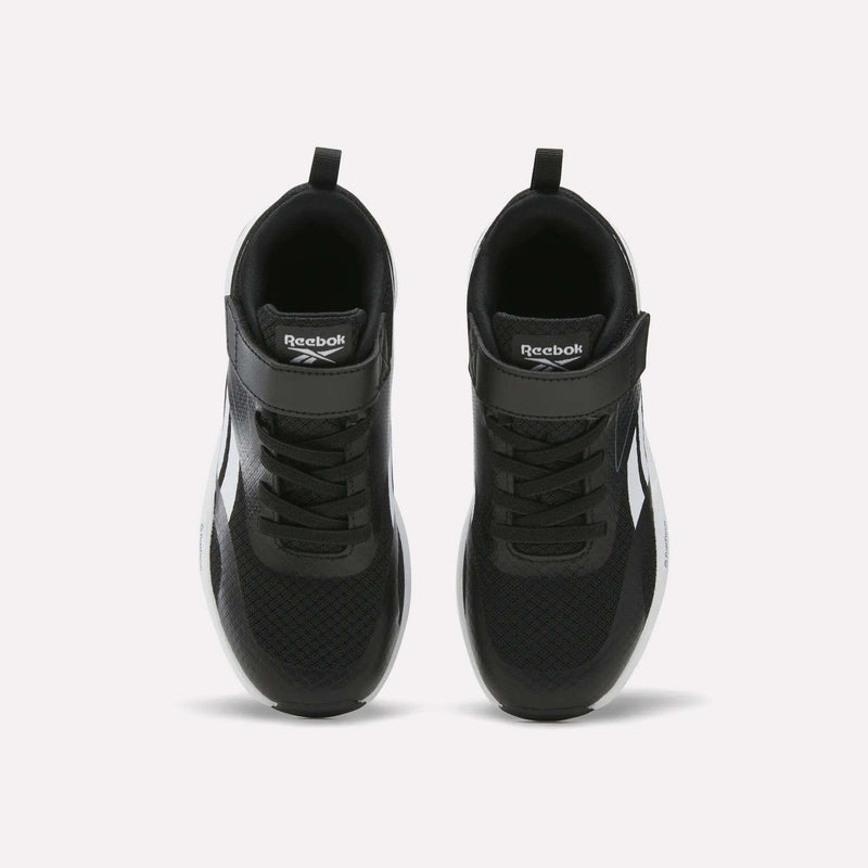 A pair of Energen Running Shoes for little kids by Reebok, in black with white accents, viewed from above. These shoes feature a Velcro strap at the top and black laces, with the Reebok logo displayed on the strap.