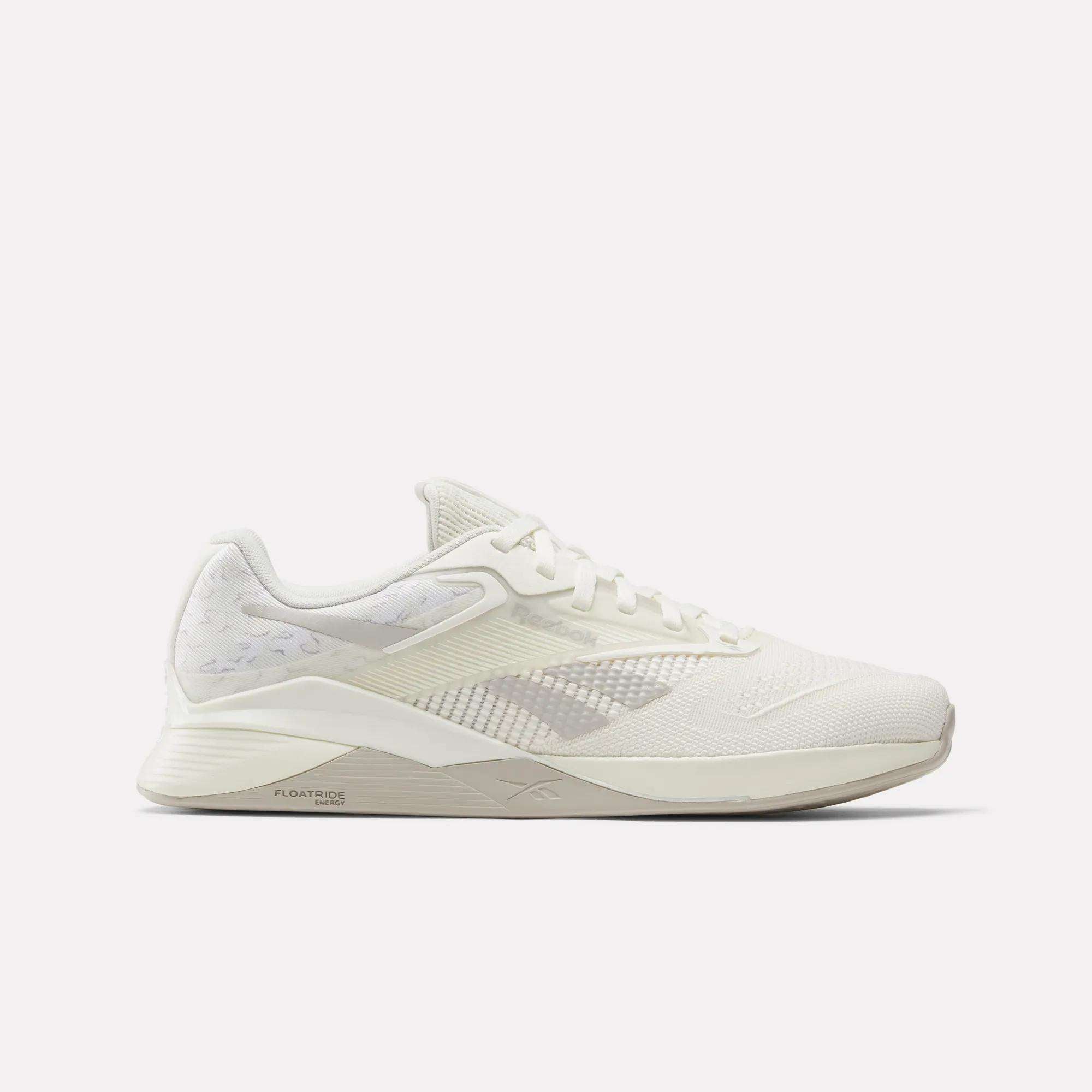 The Reebok Nano X4 Training Shoes are lightweight white athletic sneakers featuring breathable mesh, synthetic detailing, flat laces, and a textured sole, displayed in side profile against a plain white background.