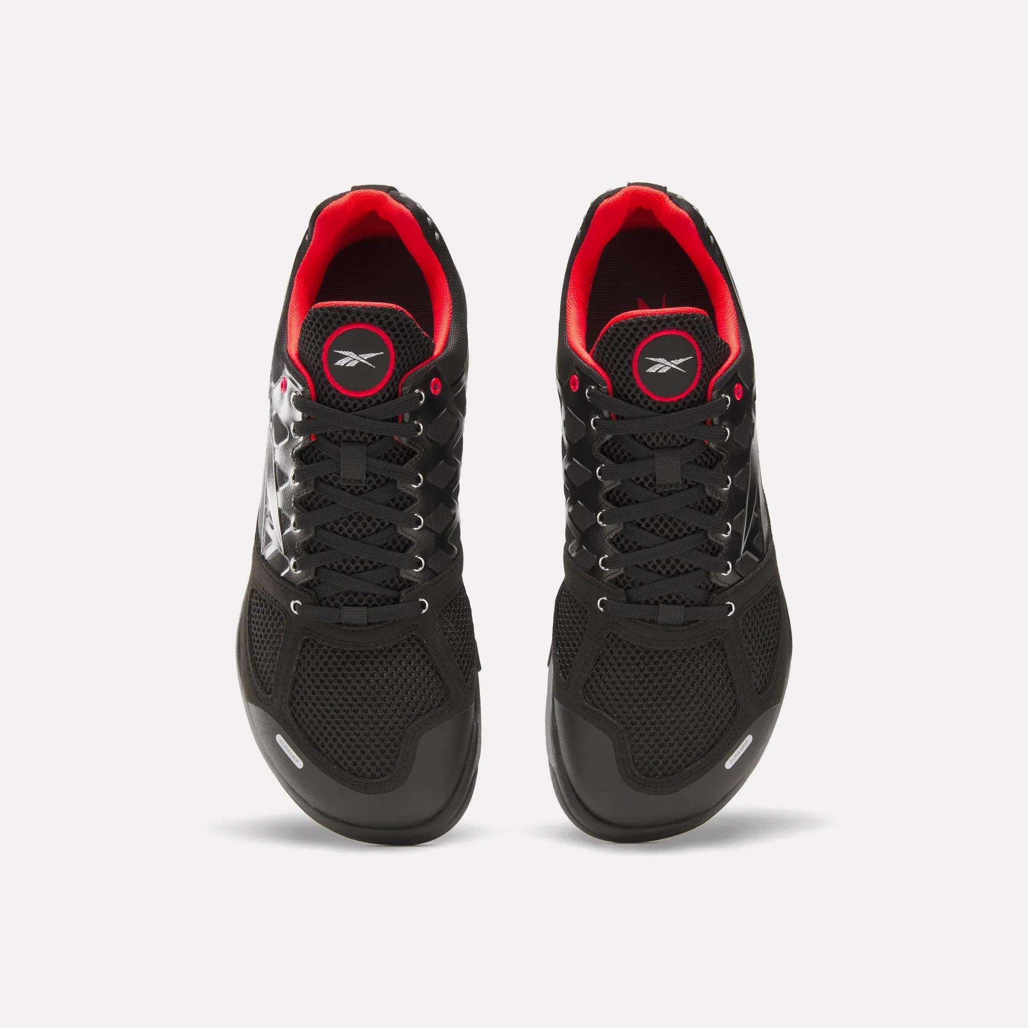 Top view of Reebok Men's Nano 2.0 Training Shoes in black with red inner lining, white laces, and visible logos on the tongue and sides—perfect for functional fitness. Shown against a plain white background.