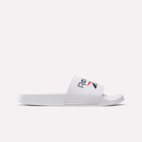 The Reebok RBK Fulgere Swim Slides are white slip-on sandals with an open toe and a wide strap featuring the Reebok logo in black, red, and gray, shown on a plain white background—ideal for poolside relaxation.