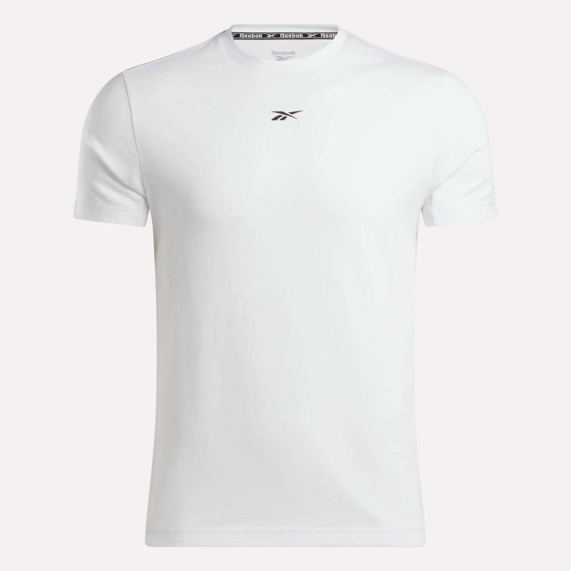 The Reebok Men's Athlete Training T-Shirt features a slim-fit design in plain white with a small black logo below the neckline, shown against a light background.