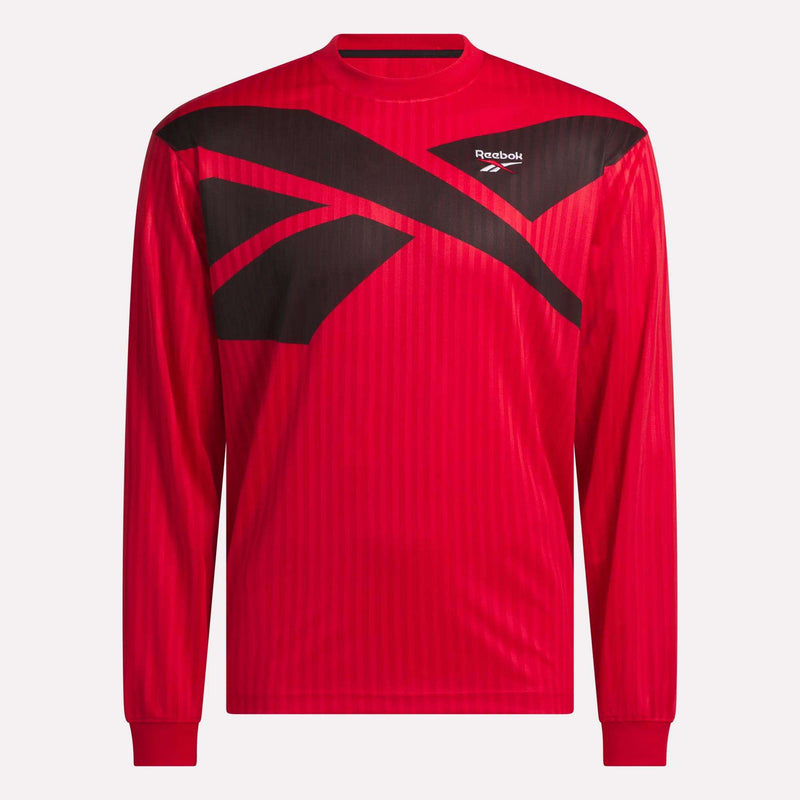 The Crosscheck Long Sleeve Jersey is a red jacquard jersey with subtle vertical stripes, bold black geometric shapes, and a white Reebok logo on the upper chest for a sporty look.