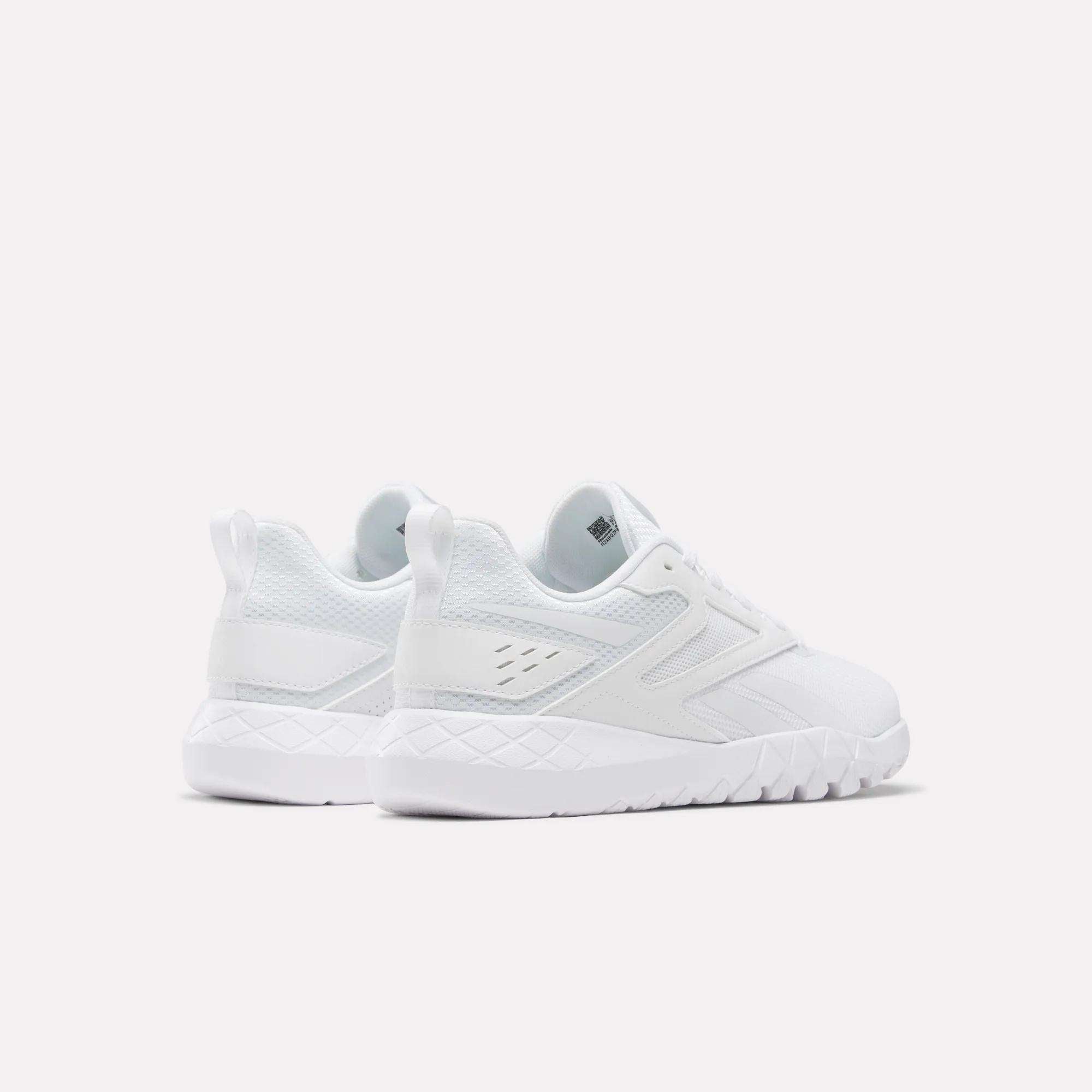 Two white Reebok Women's Flexagon Energy 4 Training Shoes are shown from the rear on a plain background. These lightweight trainers feature textured soles, responsive cushioning, subtle side details, and back pull tabs.