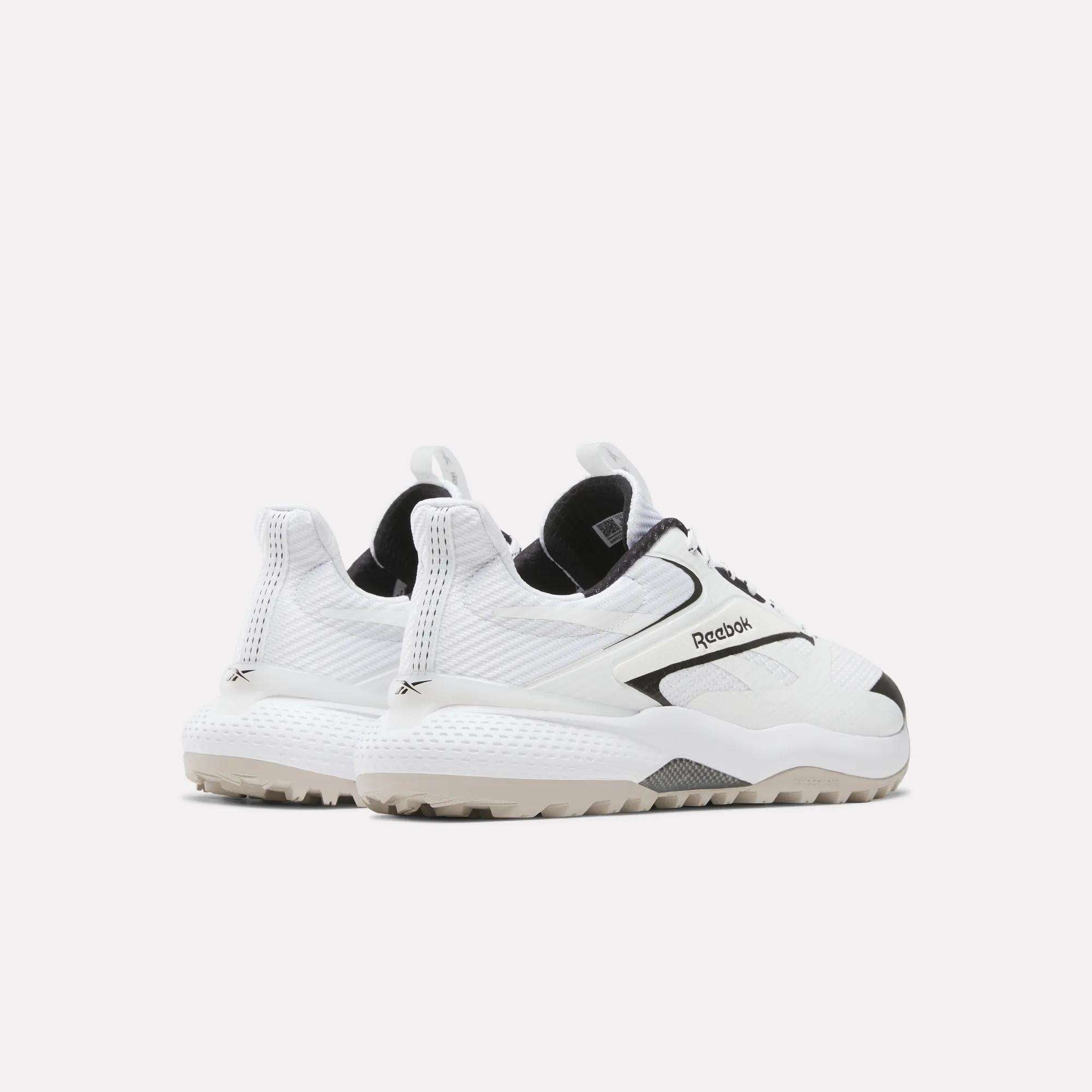A pair of Reebok Nano Golf Shoes with chunky soles and black accents, featuring a FlexWeave upper, is angled to display the sides and backs against a plain white background.