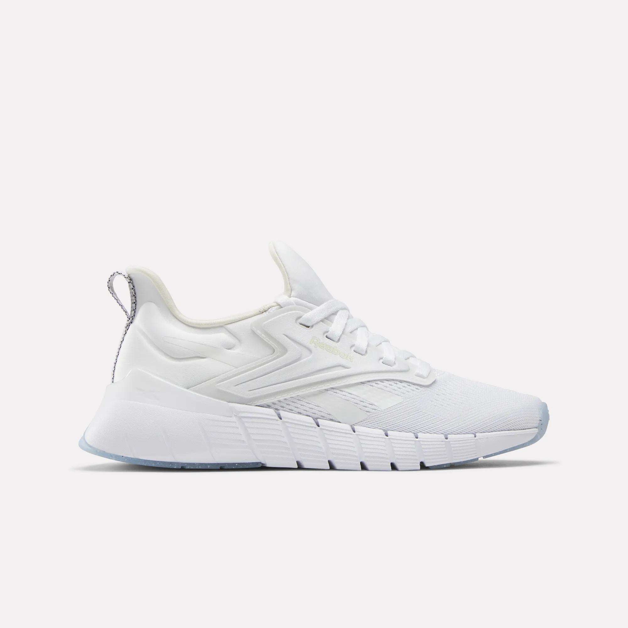 The Reebok Women's Nano Gym Training Shoes feature a white mesh upper, textured midsole, lace-up closure, and heel pull tab, shown in side profile against a plain light background.
