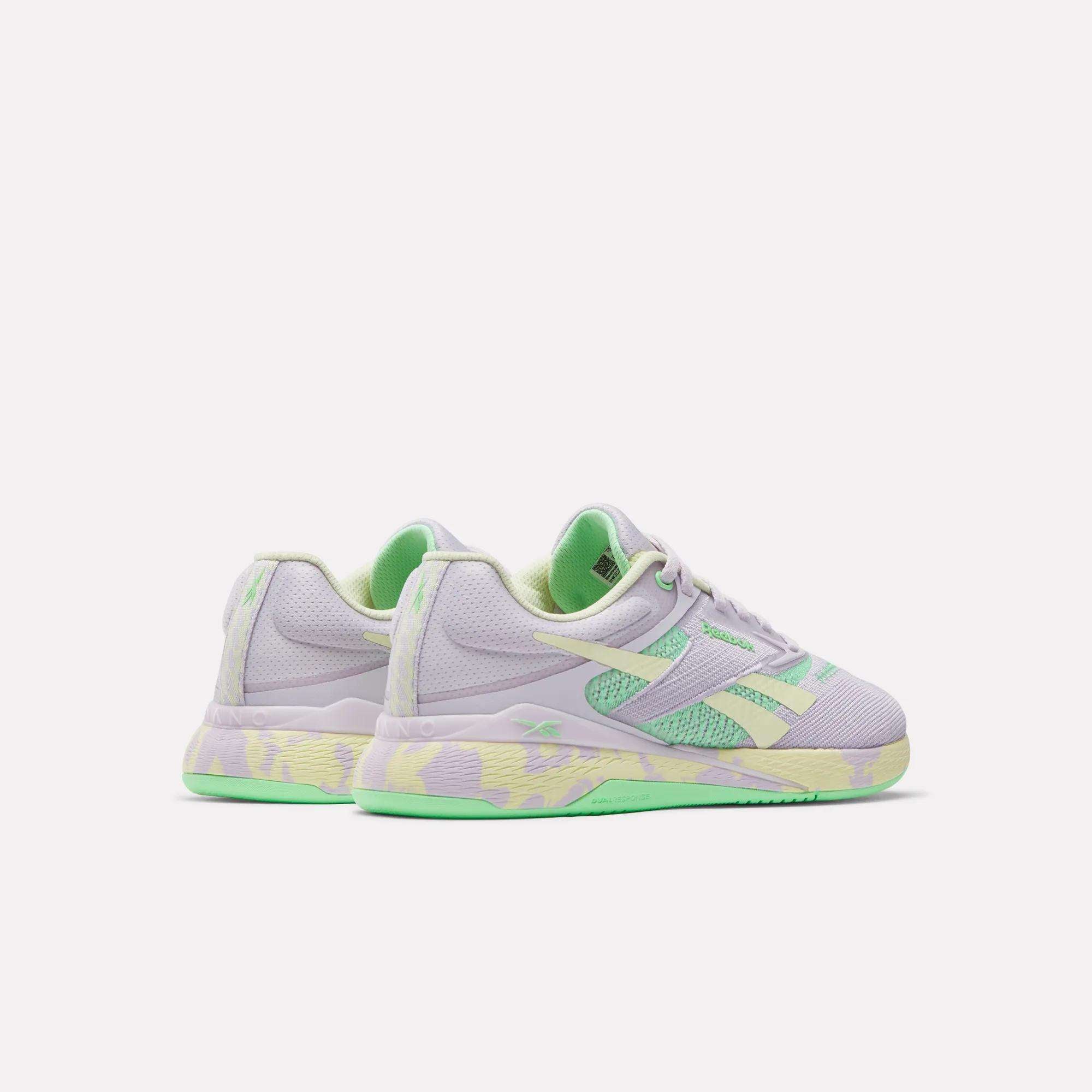 The Reebok Women's Nano X5 Training Shoes feature pastel light purple uppers, mint green accents, and yellow-green patterned soles, showcased against a plain white background.