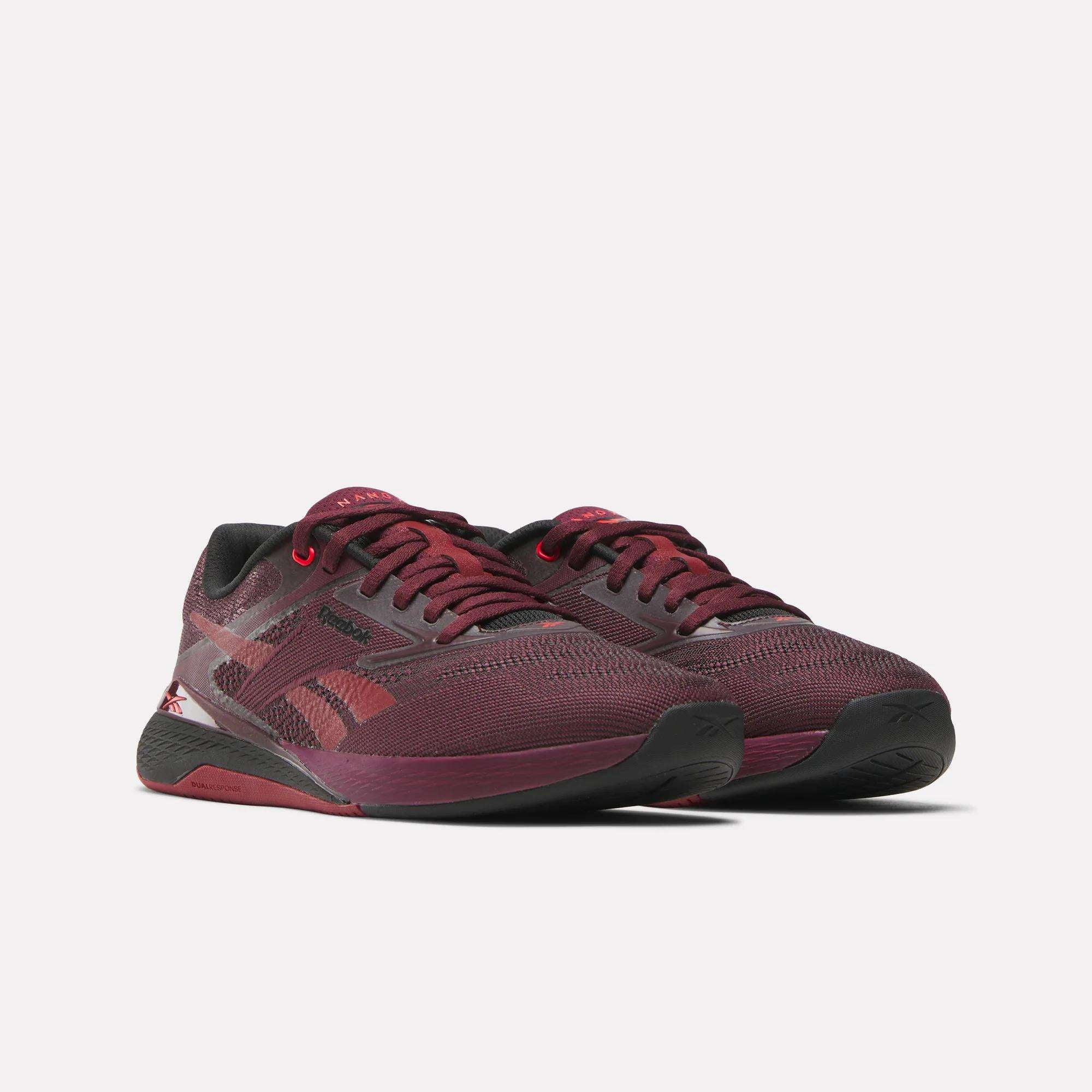 The Reebok Women's Nano X5 Training Shoes feature maroon and black mesh uppers, black soles, and side branding, designed for comfortable workouts and shown on a white background.