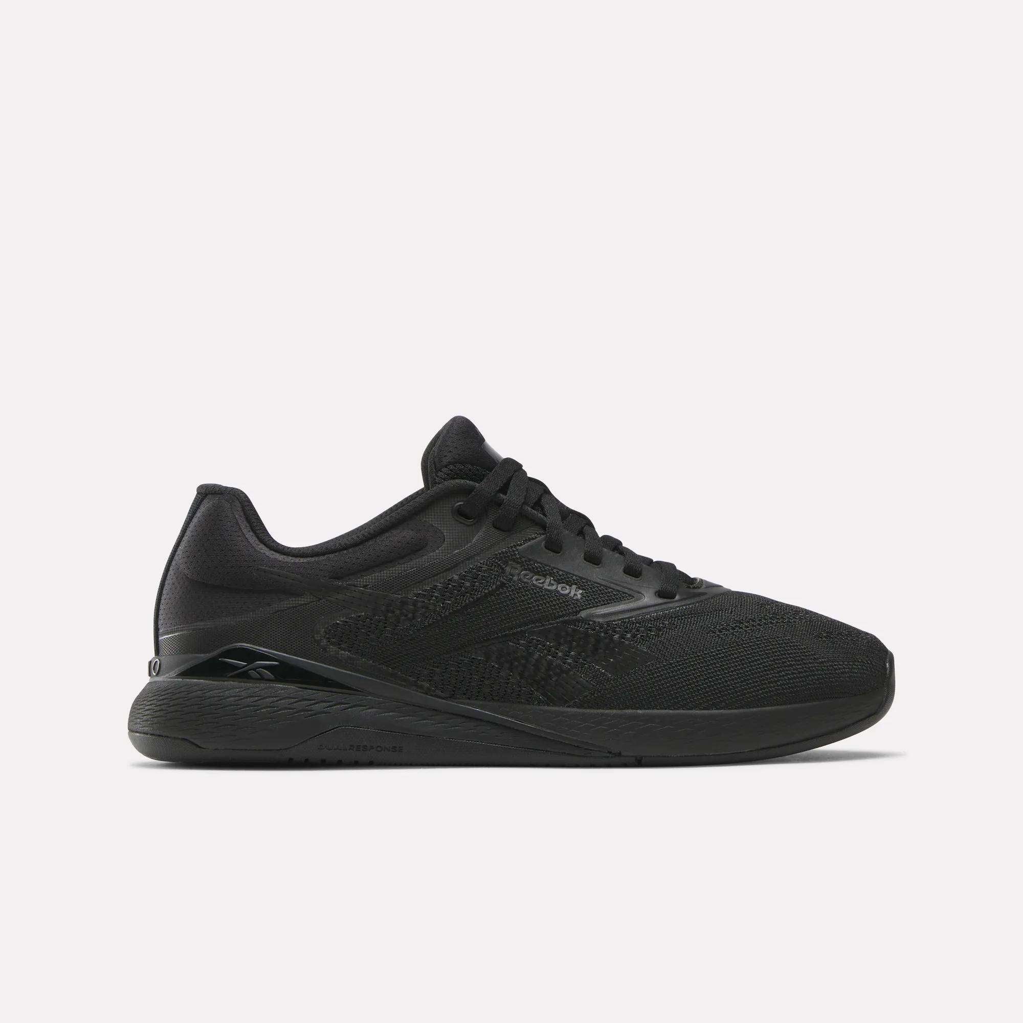 Reebok Women's Nano X5 Training Shoes are shown in black mesh with black laces and a flat rubber sole, viewed in side profile against a white background—a stylish pick for women’s trainers.