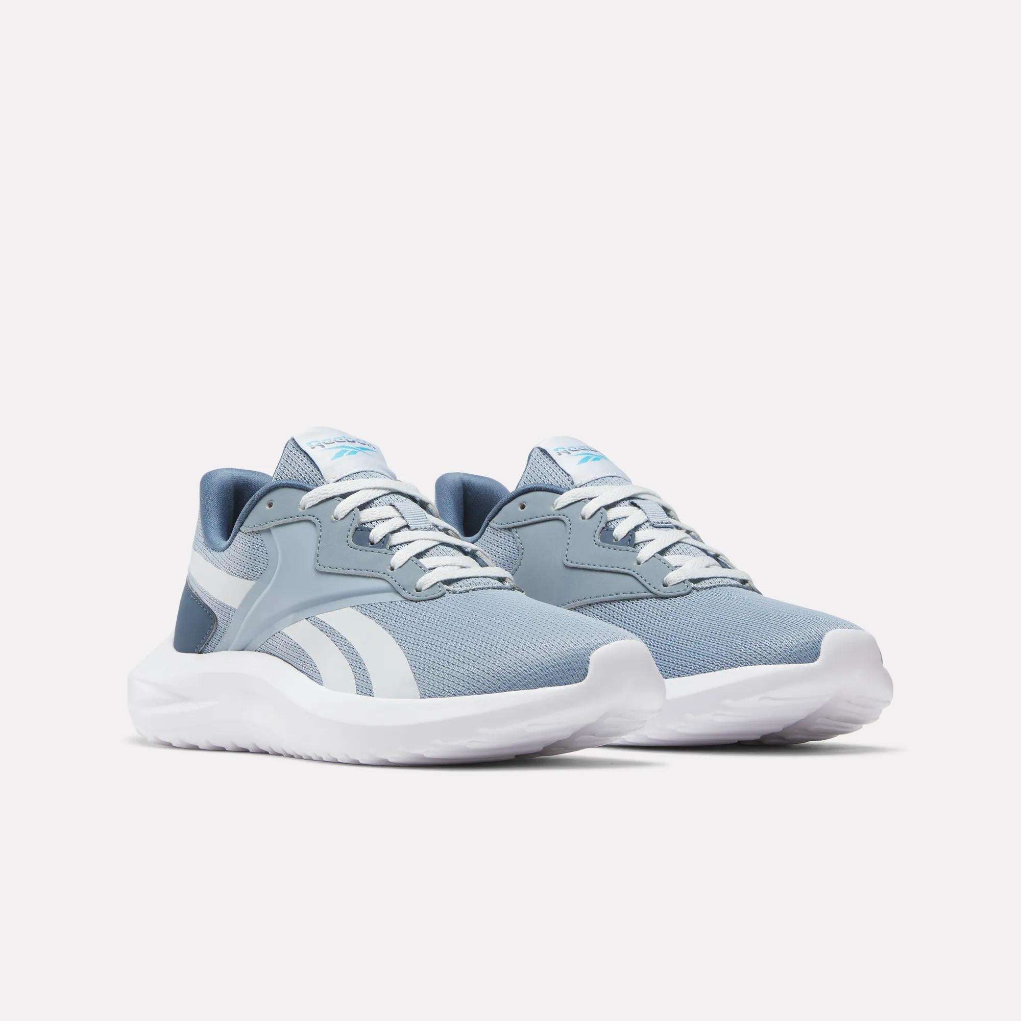 Women's Energen Lux Running Shoes by Reebok in light blue and white, featuring white laces and soles, are lightweight footwear ideal for versatile athletic use. Displayed on a plain white background.