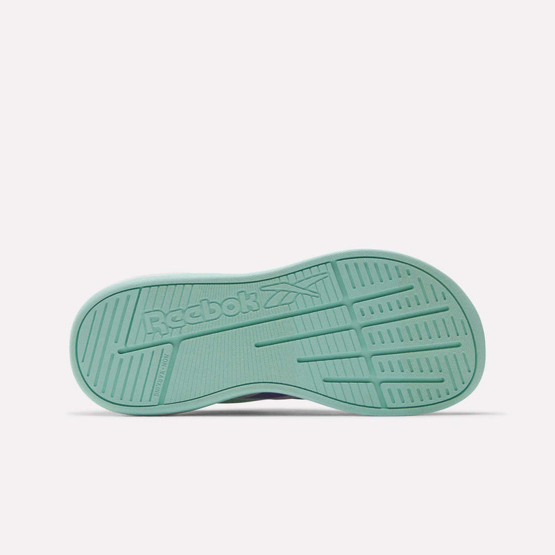 The image shows the sole of the Reebok Nano Play Slip-On Shoes for little kids, featuring a textured mint green surface with the Reebok logo and vector symbol embossed in the center.